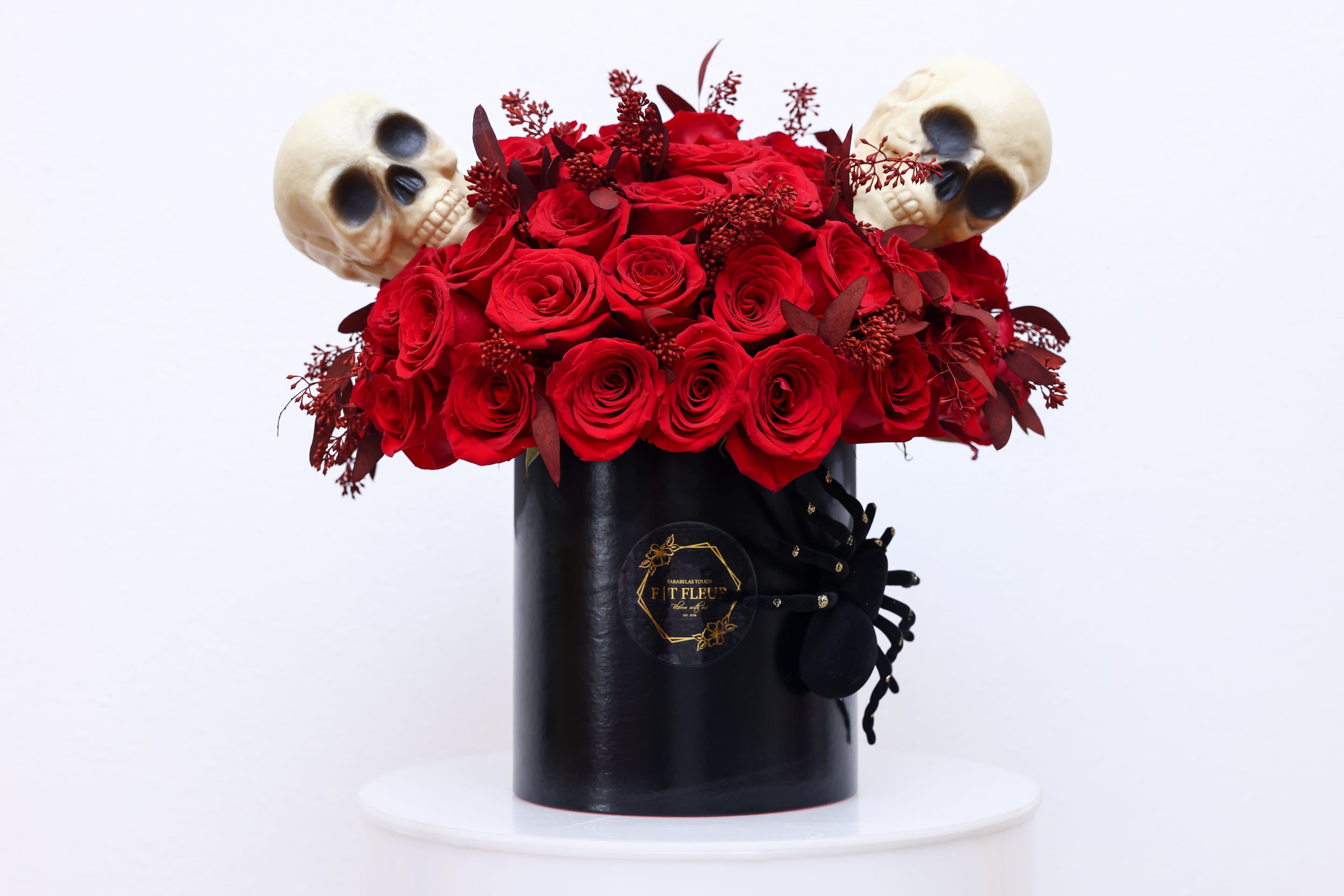 I've got a spell on you - Halloween inspired Hat box arrangement designed with red roses all around.    Due to the seasonality of flowers or supply chain issues, substitutions may occasionally need to be made. While we understand this is an inconvenience, we will fill your order with an arrangement of similar color and design style.