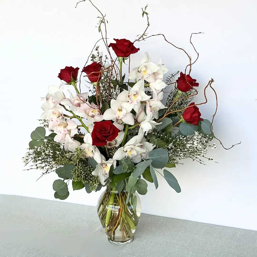 Elegant Love Elegant Love - Make your day or anniversary special with our elegant love arrangement, witch has our famous long stem red roses in combine with stunning cymbidium orchids