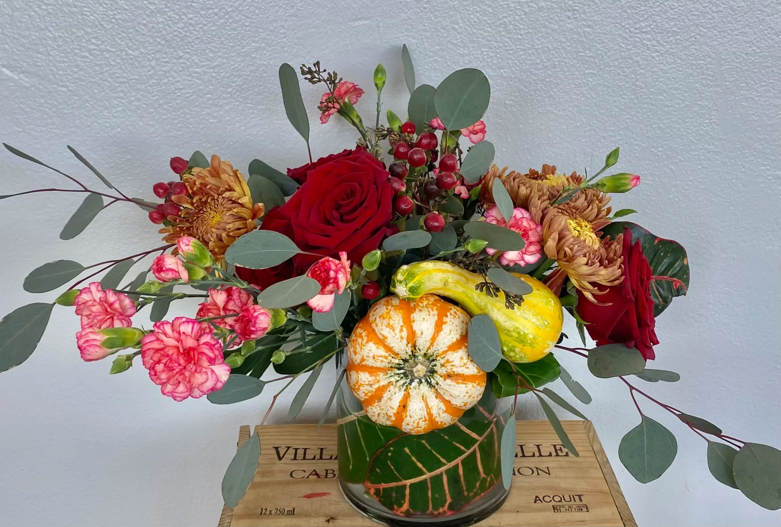 Fall Holidays  - Mixed flowers in glass vase  with pumpkins 