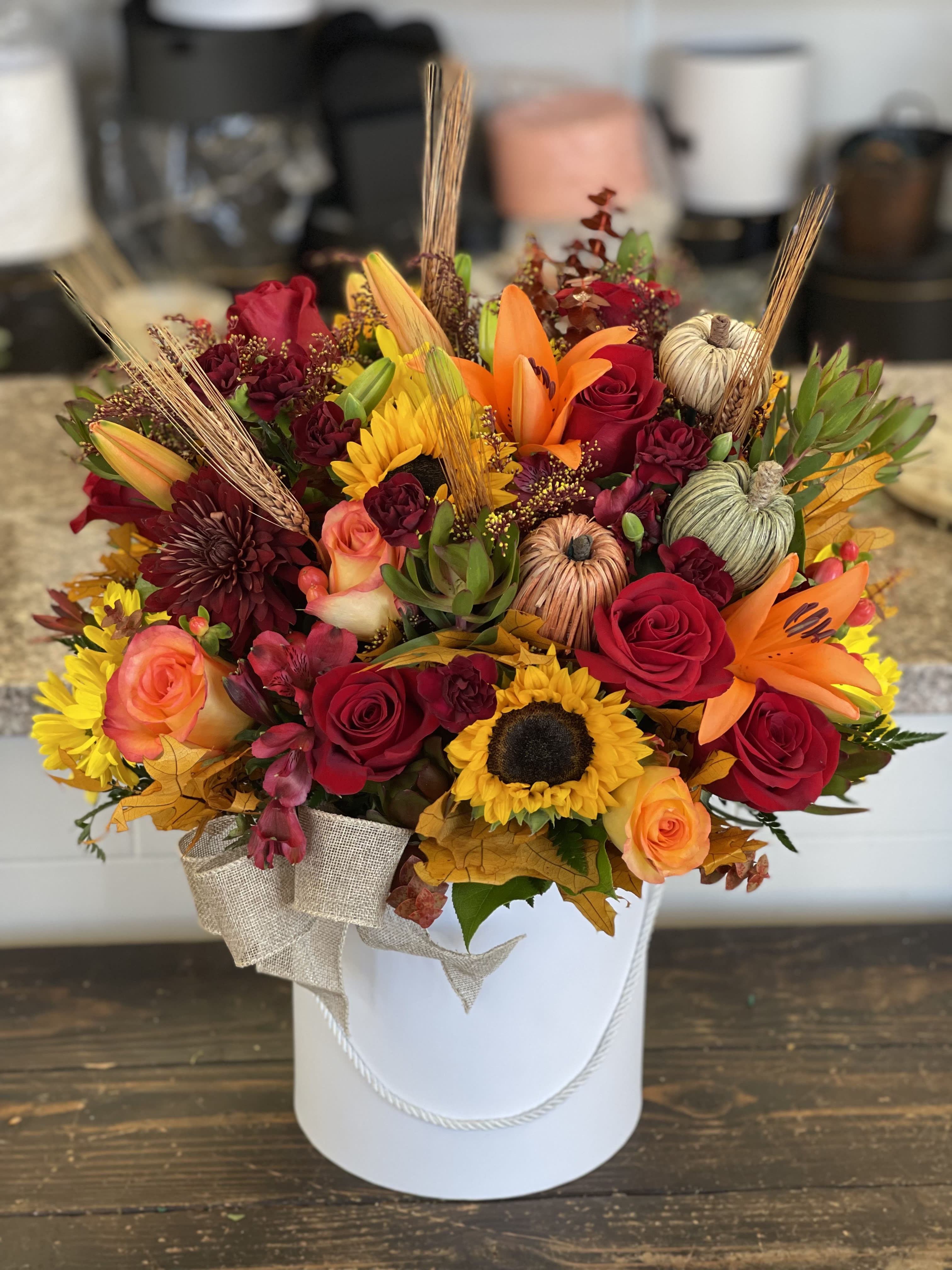 Harvest Sunset Box Harvest Sunset Box - Greet the new season with this heartwarming sunflower and rose bouquet , presented in a very modern cylinder box. We can also customize name or message on the box, if requested please add under special instructions.