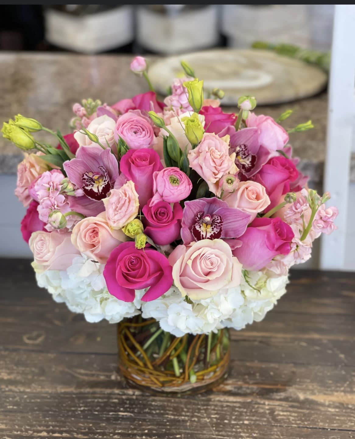 Washed in Pink Bouquet Washed in Pink Bouquet - Pretty as can be! this astonishing bouquet includes cymbidium orchids, roses, spray roses, hydrangeas, and lisianthus.