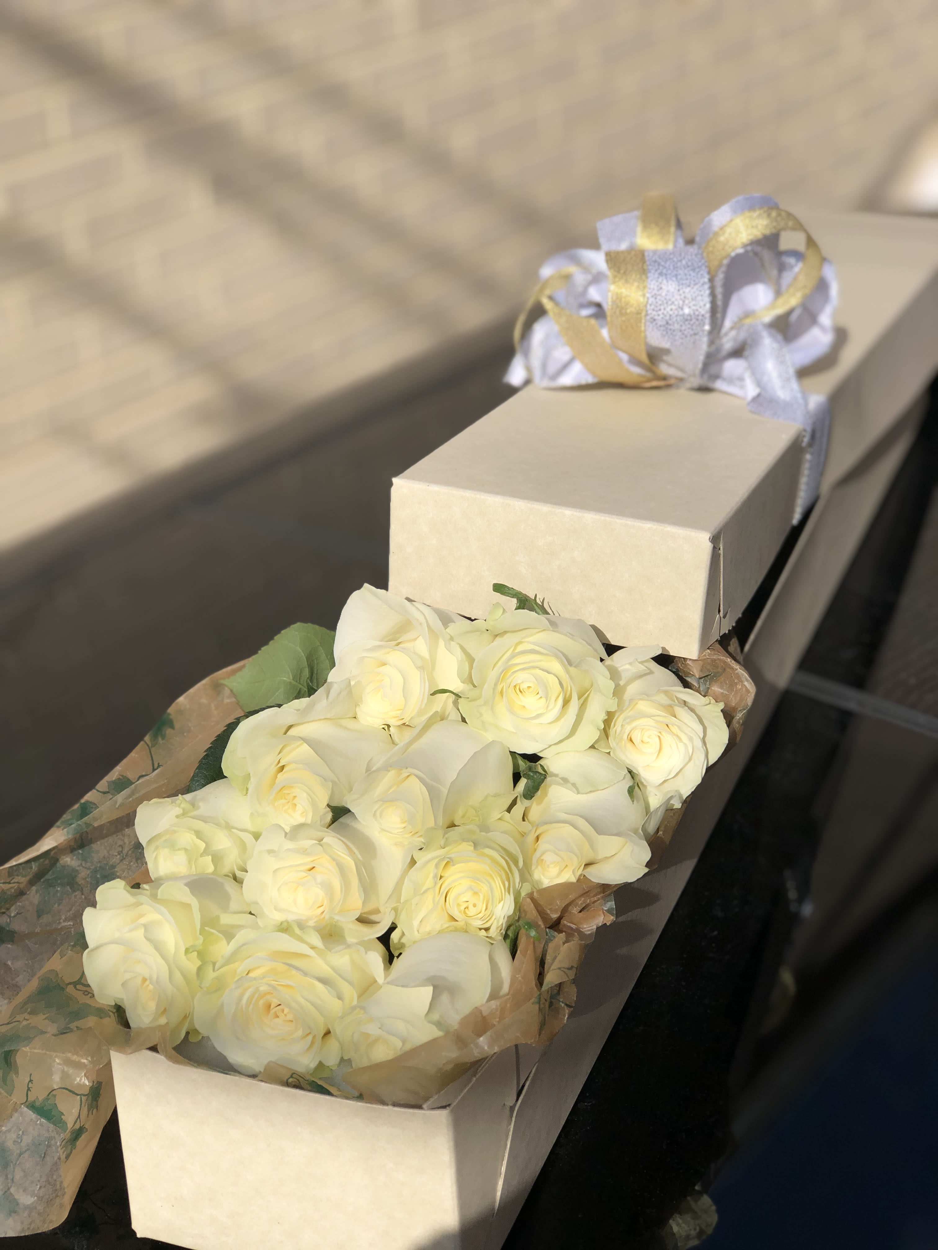 12 long stem White roses in a box - 12 Long stem white roses elegantly set in a box with greenery. Upgrade provides 24 stems.