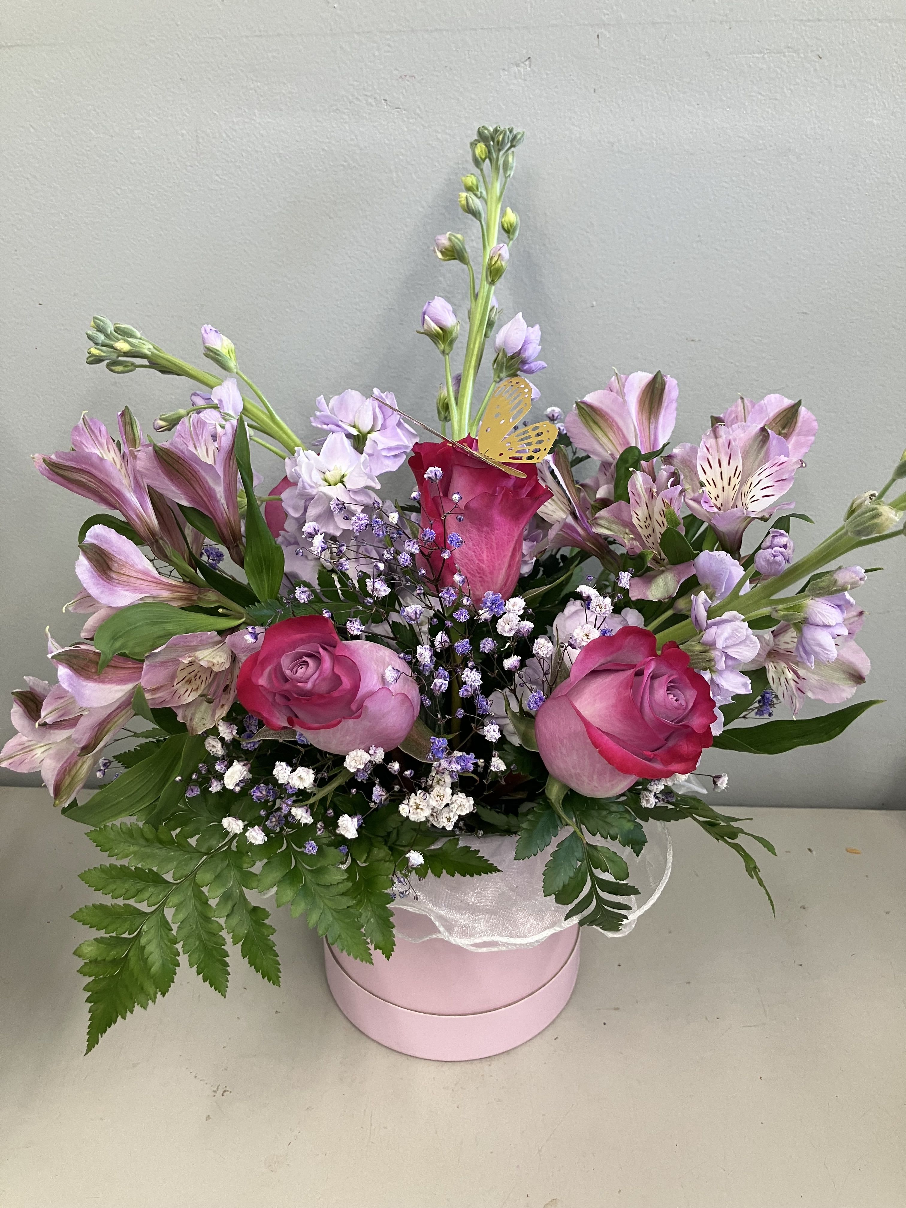 The Collette Barrel Arrangement The Collette Barrel Arrangement - When the breeze is warm and the lilacs are blooming life becomes more joyful! roses, stock, alstroemerias and soft fillers in a lilac barrel container make the perfect spring bouquet, inspired by my sister Collette!