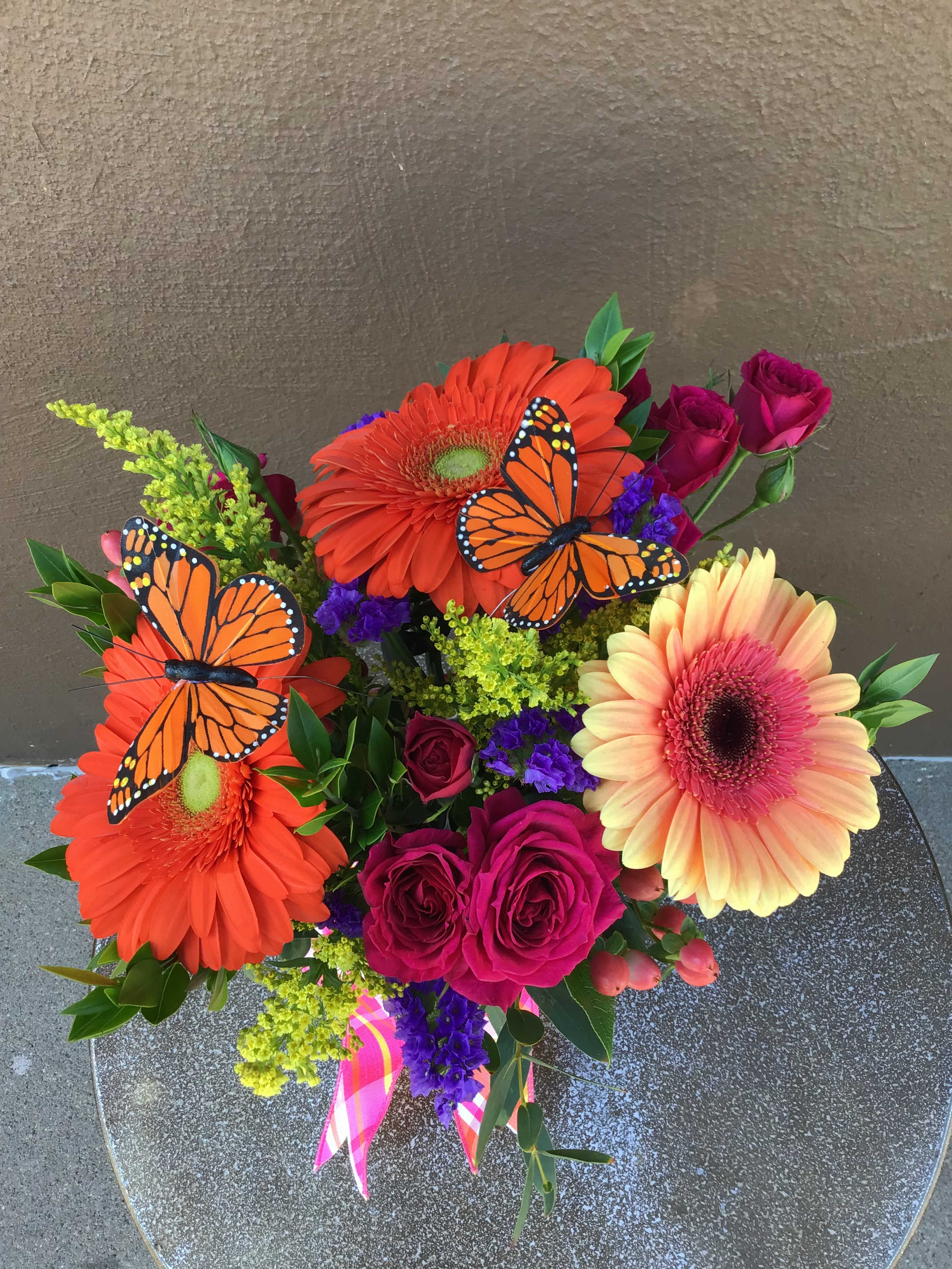 Bright fun festive - Bright flowers and accents bring a super happy vibe to this arrangement!