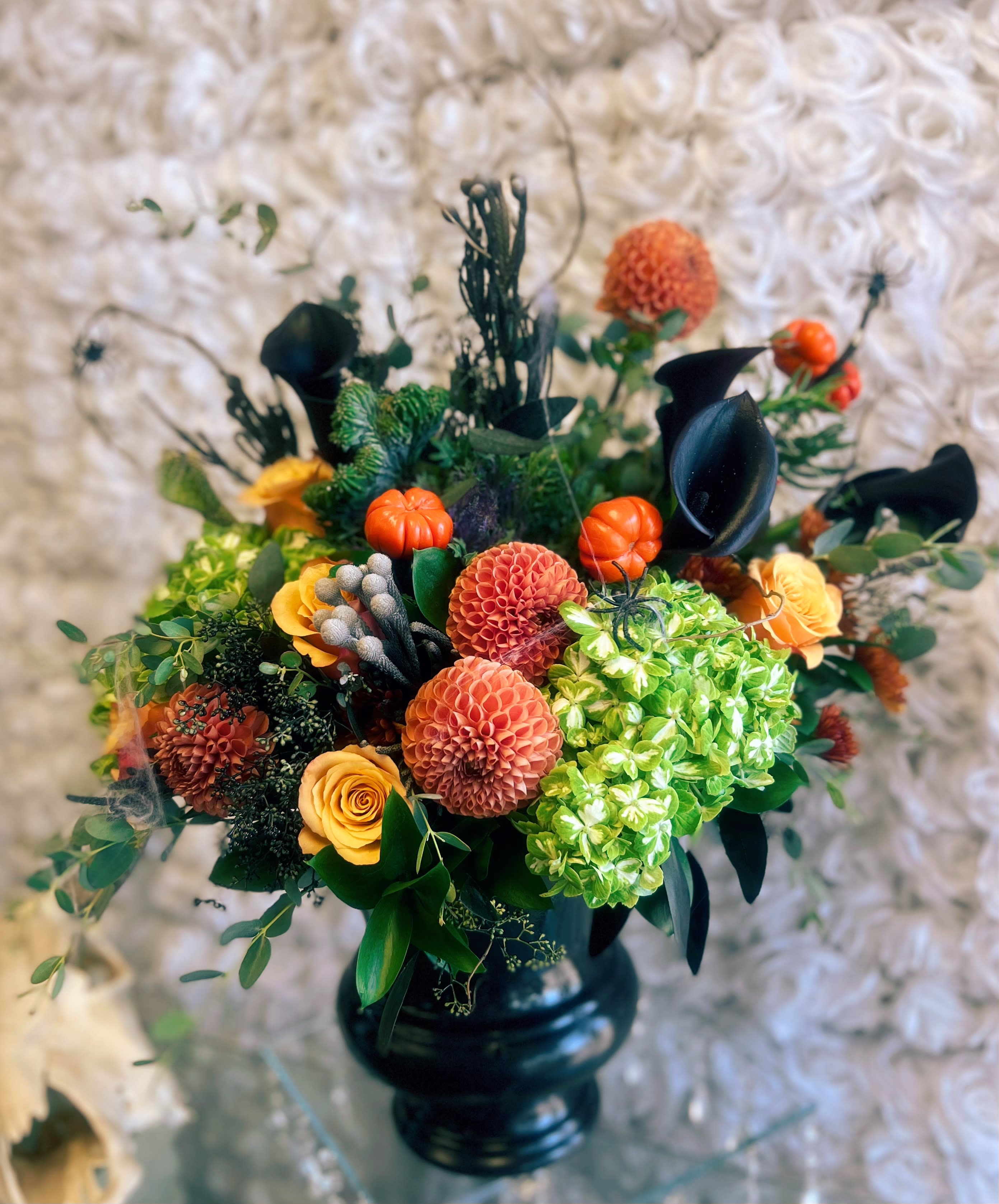 Halloween Spooktacular  - A Spooktacular way to say happy halloween to your nearest and dearest.  Vase container, Colors and florals may vary depending on availability.  Shown is a standard arrangement,  deluxe adds more flowers to the same vase for a fuller look. Premium is a bigger vase and more flowers.  