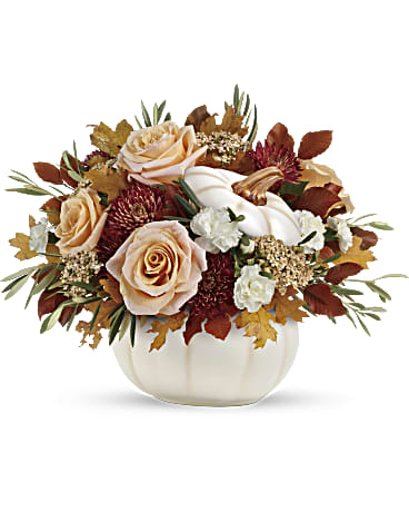 Harvest Charm Pumpkin - Elegant peachy cream roses blend with the heartwarming hues of autumn in this charming bouquet, artfully arranged in a white lidded pumpkin bowl, a versatile fall decor favorite!