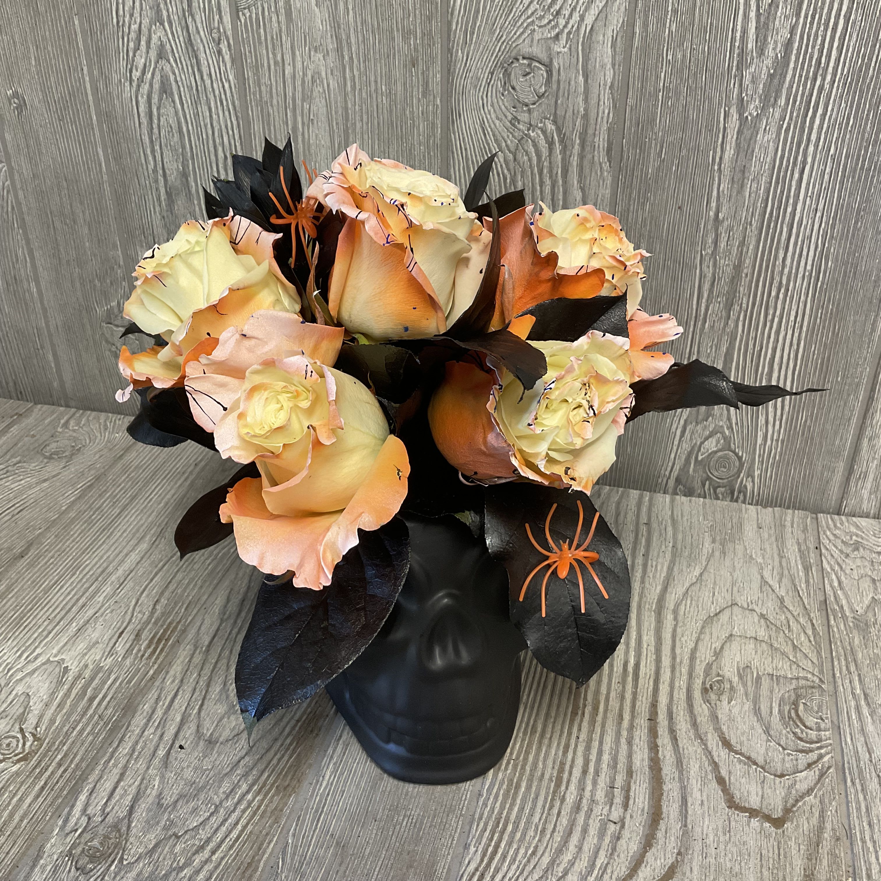 Evermore - Beautiful painted fresh cut roses arranged in a ceramic black skull keepsake container. Flowers and colors may vary. 