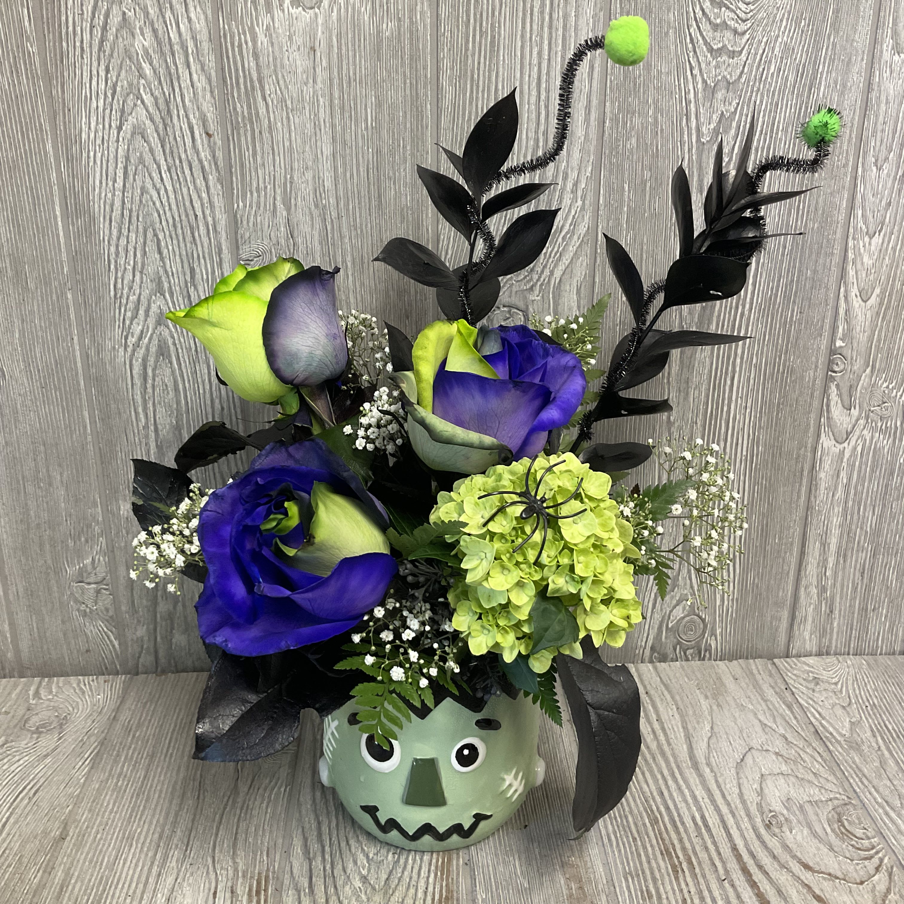 Frankie - Beautiful dyed roses arranged in a ceramic Frankenstein’s monster keepsake ceramic container. Colors and flowers may vary. 