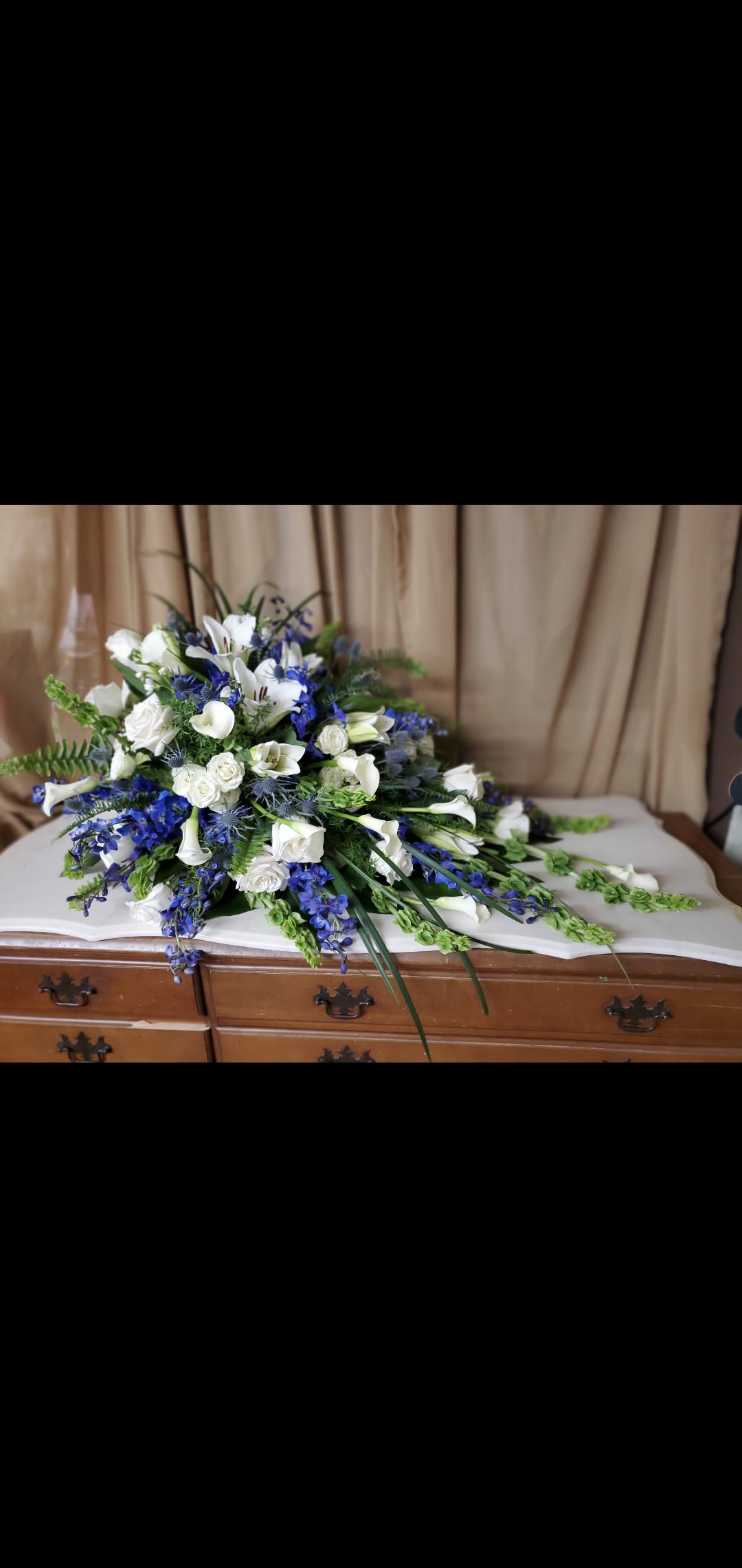 Calm Waters Calm Waters - Lilies, roses, callas, delphinium filler and greenery. Colors may be changed to preference. give ample time to order.