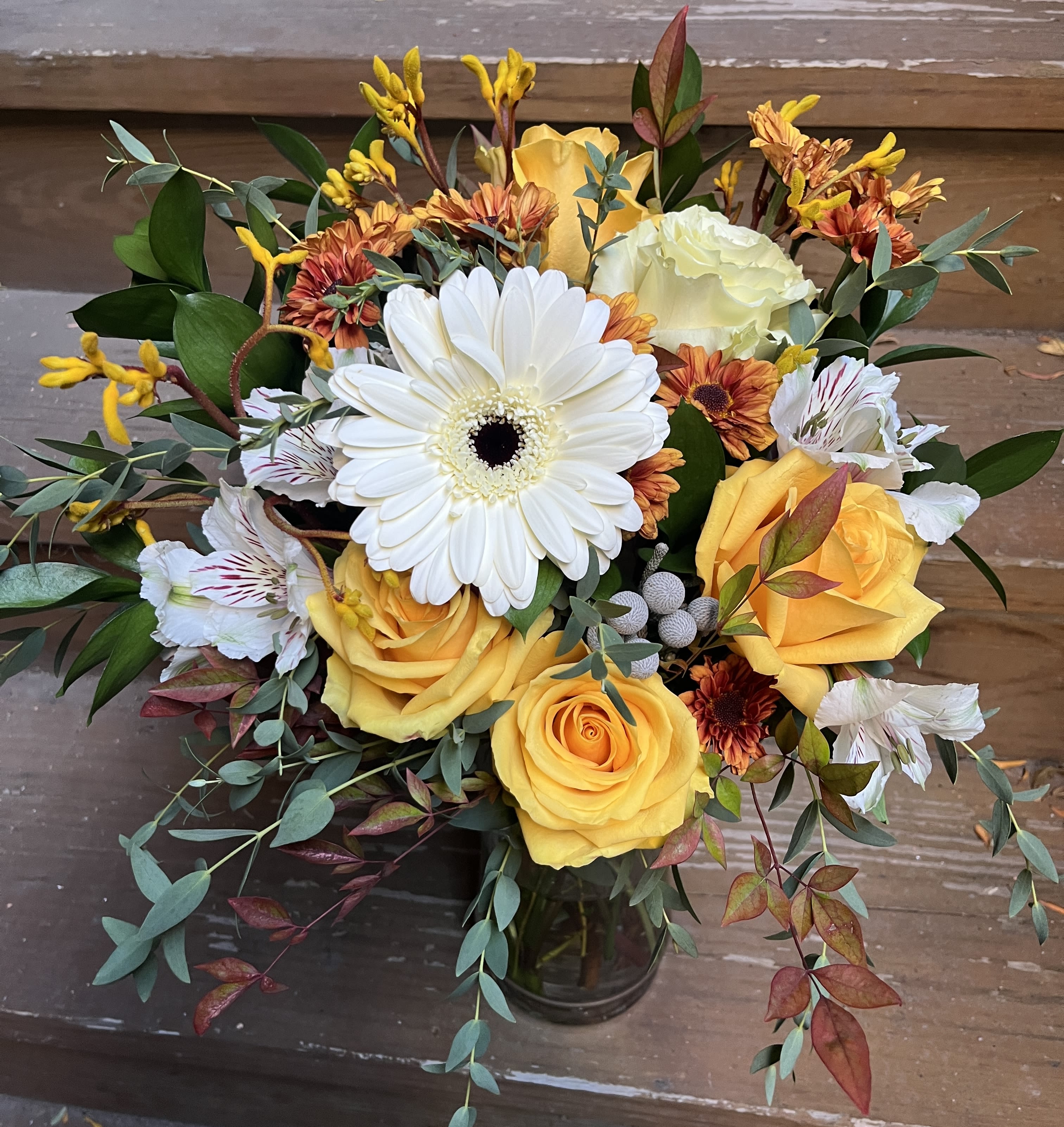 Yellowstone - A Fall Favorite of soft yellow roses, a focal Gerber daisy, fall mums, accent floras and fall foliage.  