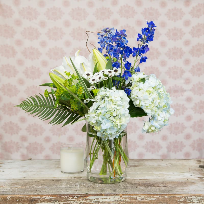 Tranquility Tranquility - This structural arrangement keeps the eye moving from dark blues into whites. Accented with a variety of greens, this arrangement is surely to please anyone looking for something different but versatile.