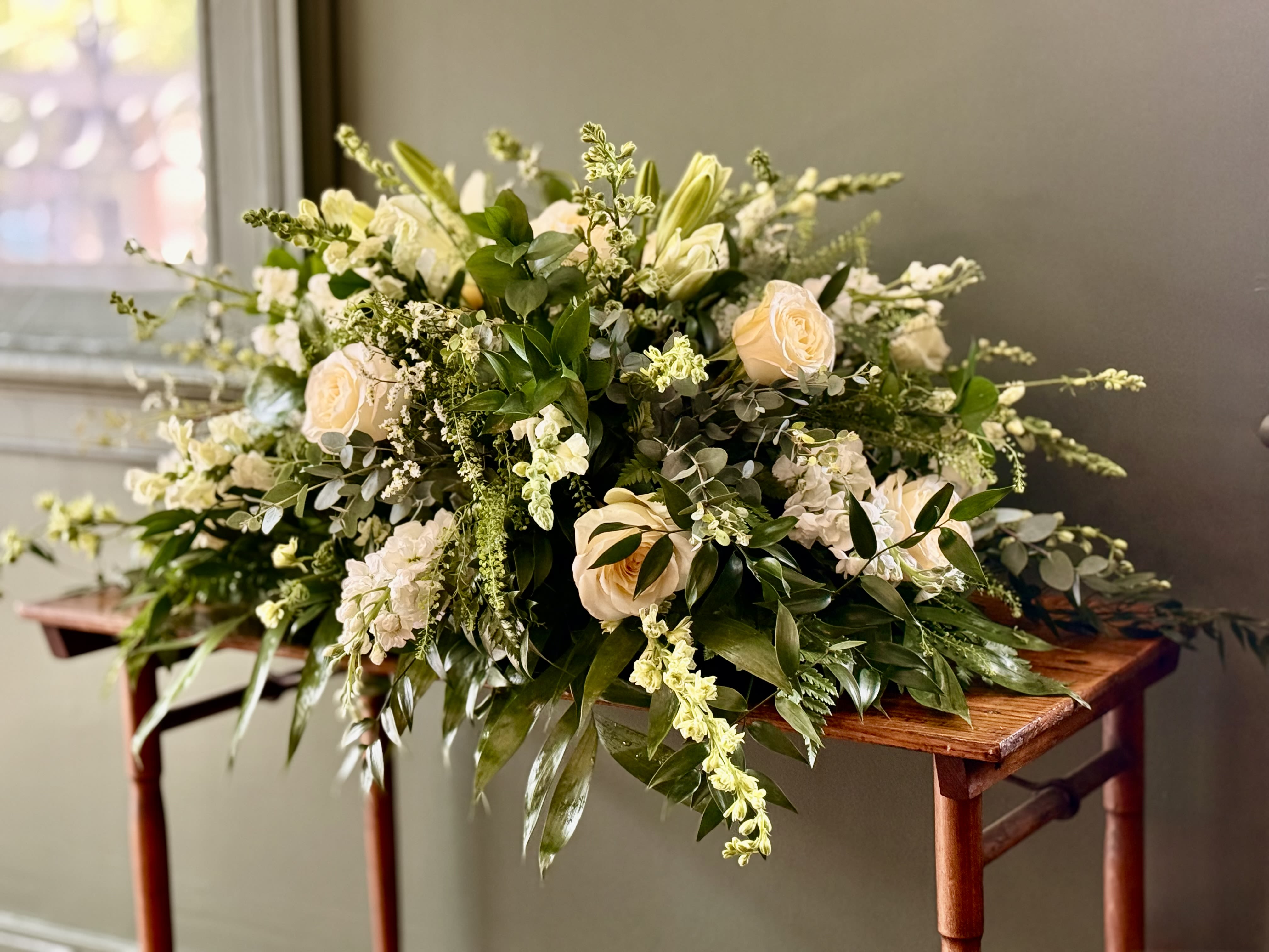 All White Casket Spray All White Casket Spray - Show purity of love with a mix of all-white flowers that’s as gentle and pure as a cloud. Accented with a mix of greenery, fragrant white flowers create a lovely and traditional casket spray.