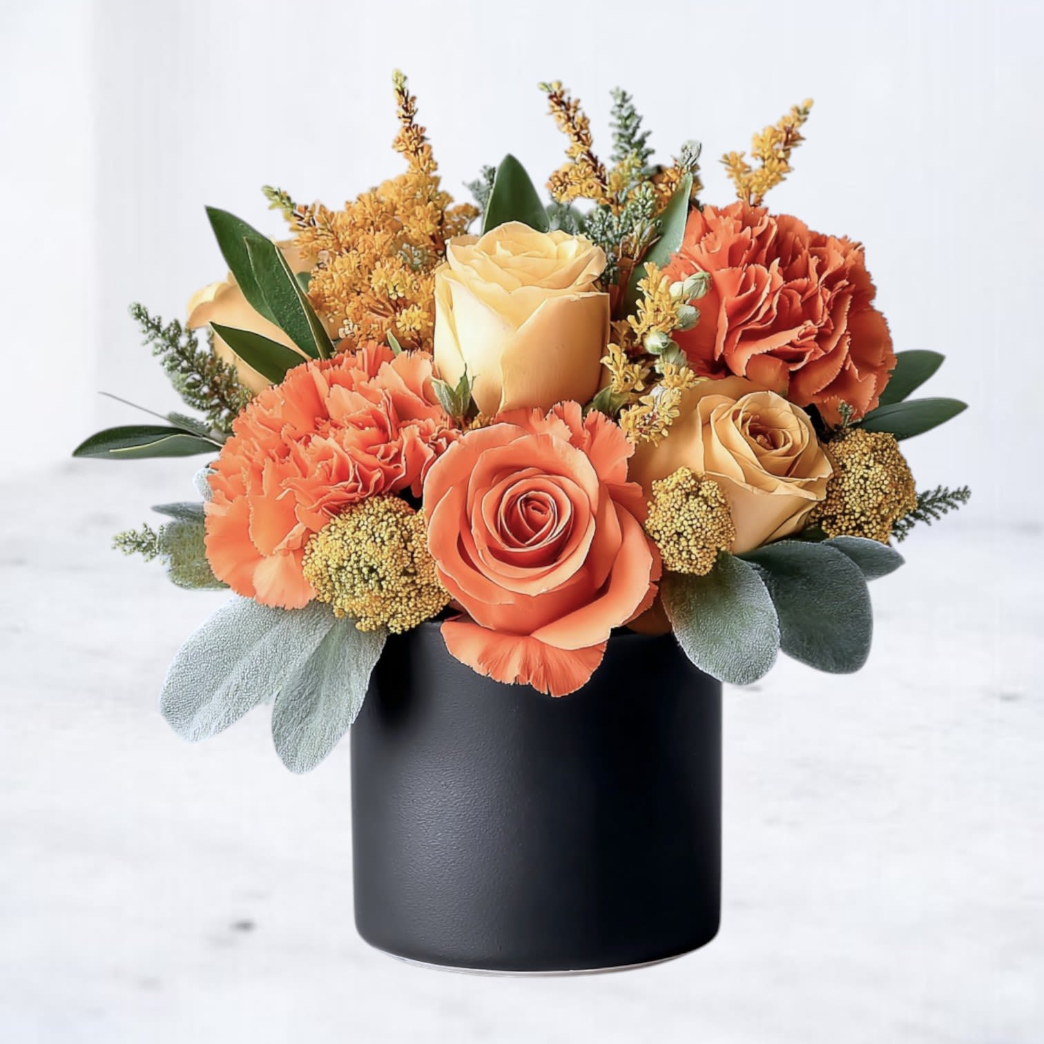 Paprika Pop Paprika Pop - Paprika Pop is a bold little burst of color designed to brighten any day. Featuring radiant orange and yellow roses, coral carnations, and vibrant seasonal textures, this compact arrangement brings the heat with an energetic palette that's anything but ordinary. Arranged in a sleek 4x4 black cylinder vase, Paprika Pop is a small but mighty design—perfect for desks, side tables, or as a cheerful pick-me-up. Available for same-day delivery in Houston and surrounding areas, it’s a spirited way to send sunshine, smiles, and style.