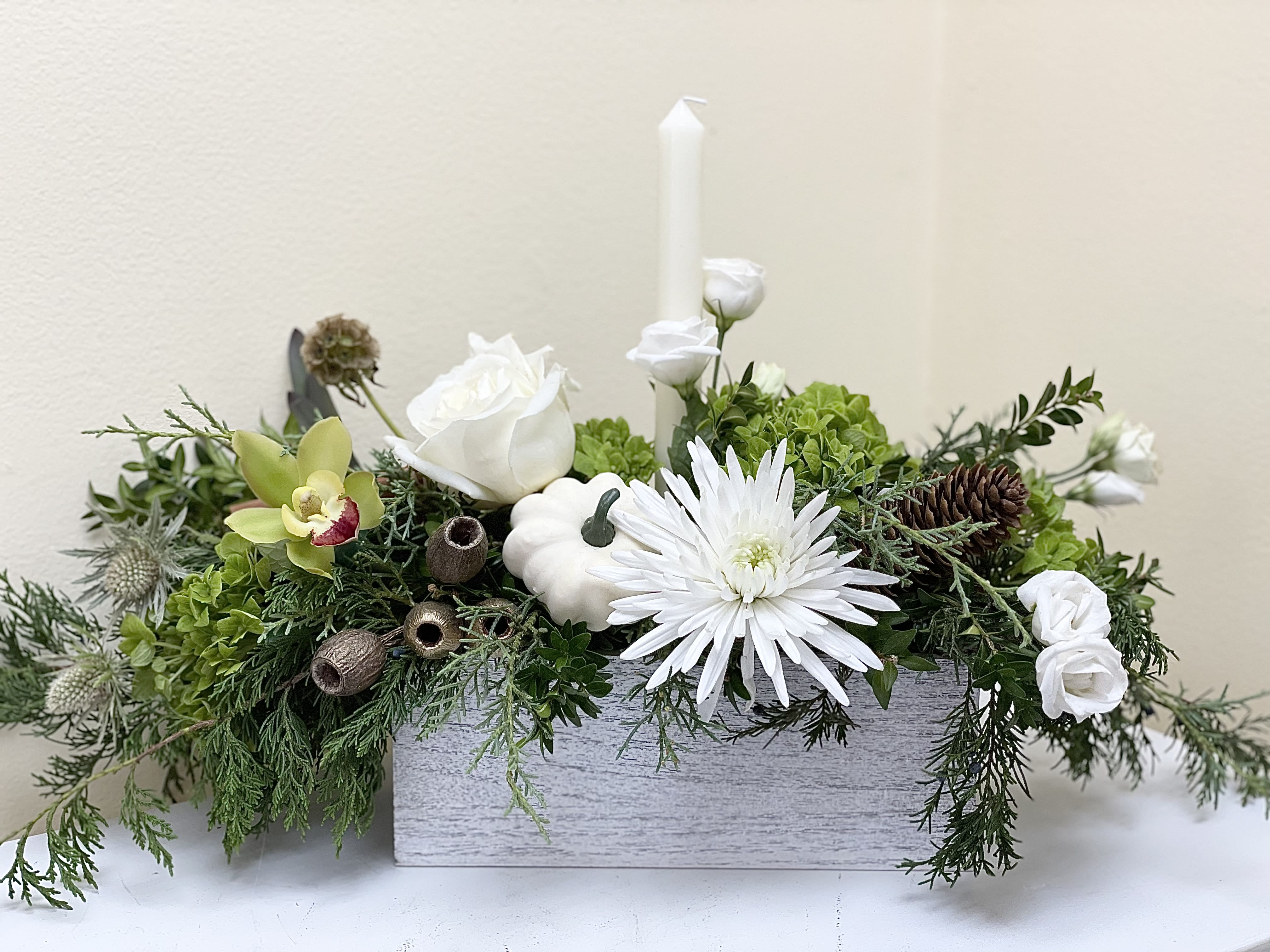 Centerpiece sending thoughts and Love! - A beautifully designed centerpiece to grace a holiday table, designed with a variety of greens and contains natural elements, pods and cinnamon, comes with a taper candle.