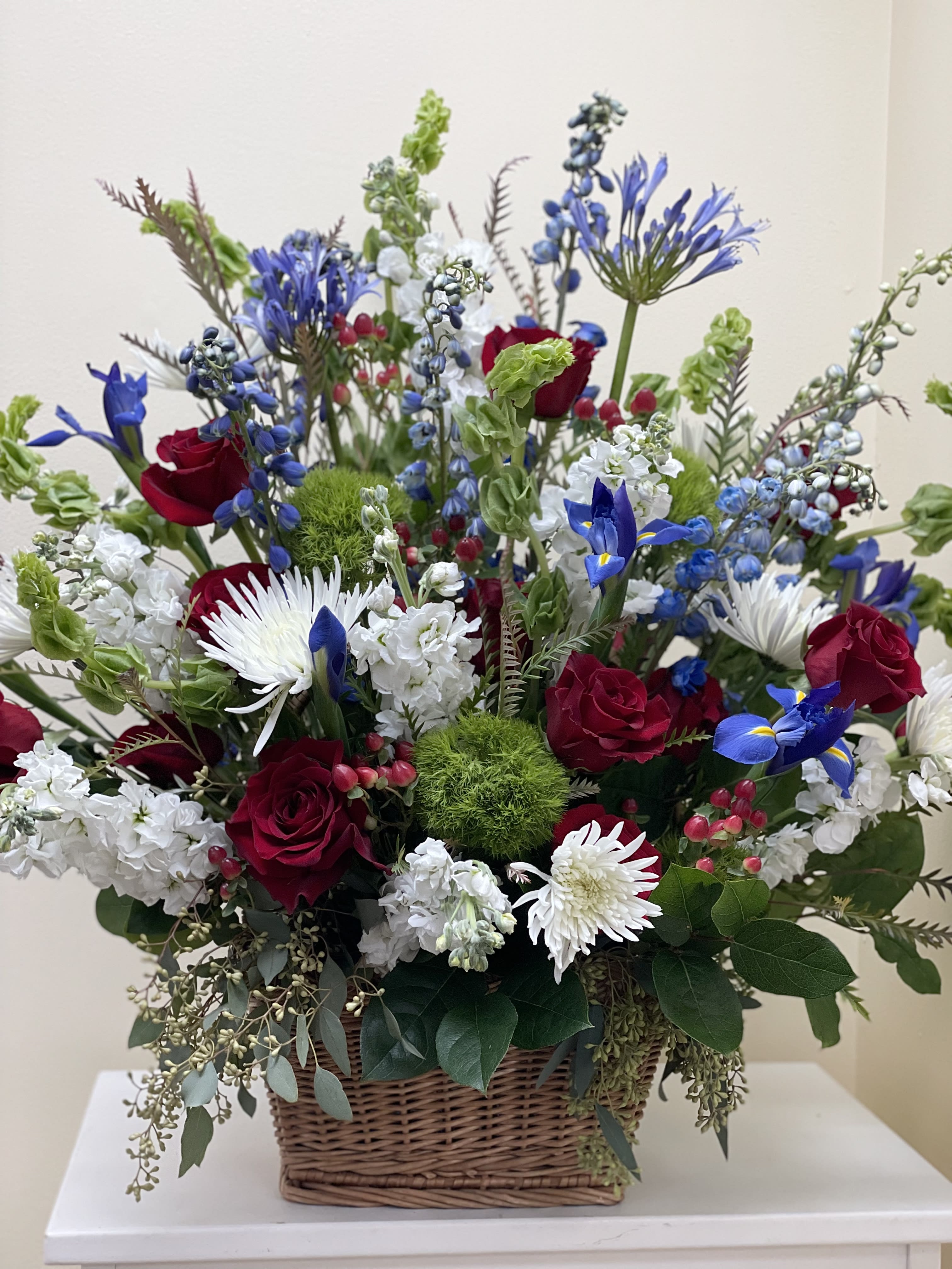 Sympathy Blue, White and Red - A seasonal, beautiful, tall bloomed designed in a textural basket. 
