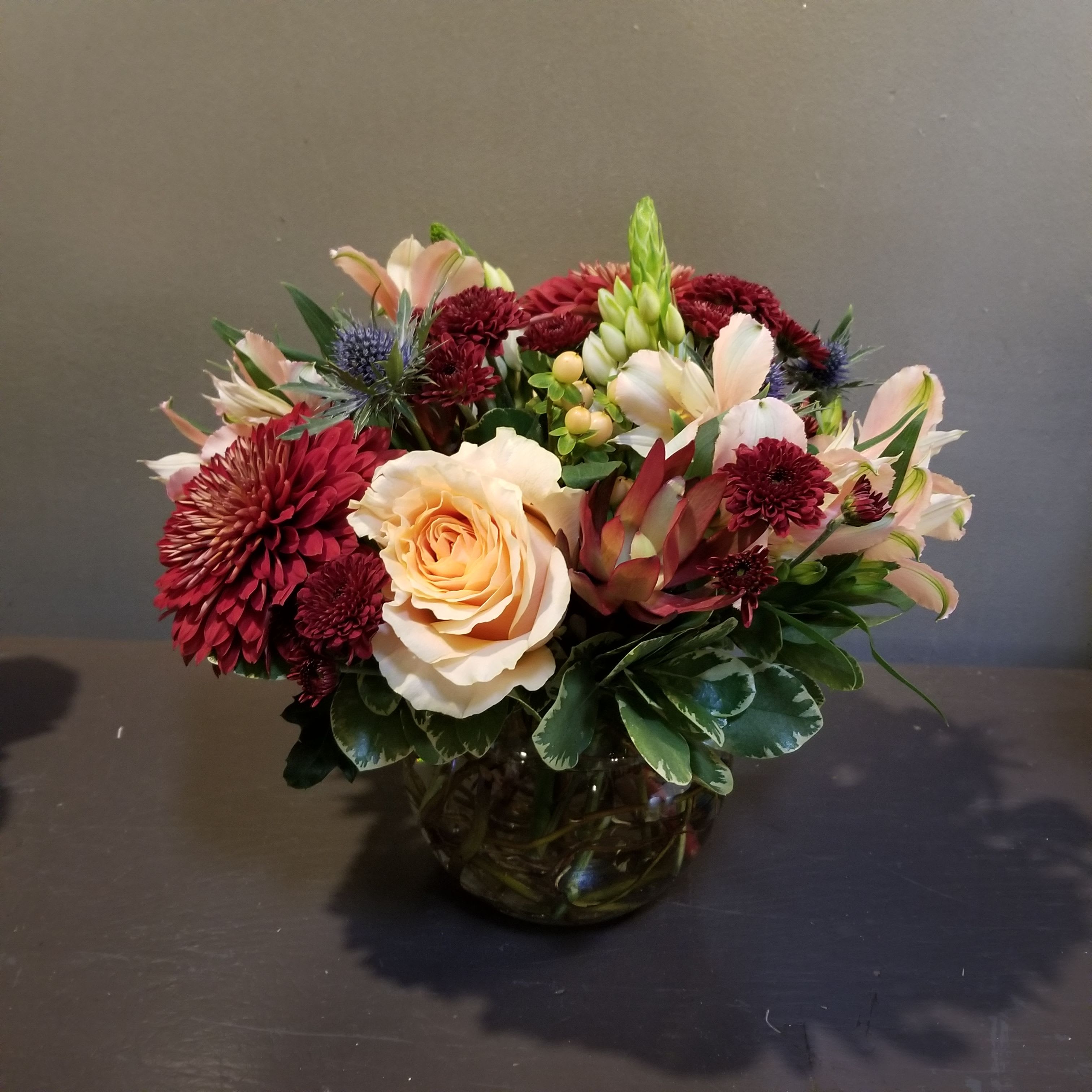 Autumn Centerpiece Autumn Centerpiece - A sweet bouquet to brighten everyone's day! Arrangement measures 11" tall and 11" wide and arrives in a glass bowl.