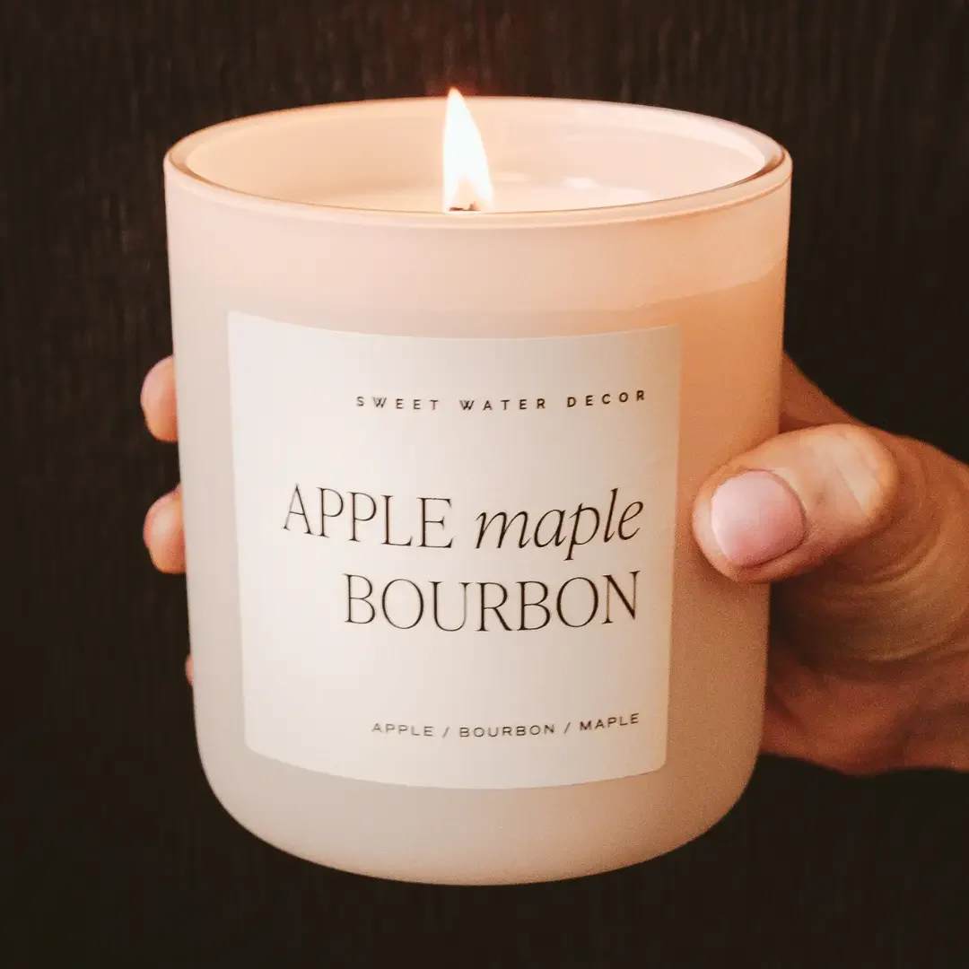 Apple Maple Bourbon 15 oz Soy Candle Apple Maple Bourbon 15 oz Soy Candle - Our Sunday Brunch fragrance perfectly captures the sweet scent of apple and maple with balanced hints of bourbon and vanilla. Although considered more of a Fall fragrance, this can be enjoyed year-round. Be reminded of a sweet brunch and the cozy aromas it brings! SCENT NOTES: • Top: Apple, Cinnamon, Orange • Middle: Bourbon, Butter, Coconut • Base: Maple, Vanilla CANDLE INFO: • Size: 15oz | 334g Net Weight | 3.25x3.63x4" • Burn Time: 70+ Hours • Includes wood lid • Wick: 100% Cotton (Lead and Zinc Free) • Wax: Proprietary Soy Based Wax Blend | Vegan, Non-GMO, Kosher • Premium Fragrance Oil • Gluten Free, Phthalate Free, Non-Toxic • Made in Pittsburgh, PA • Style No. CL140