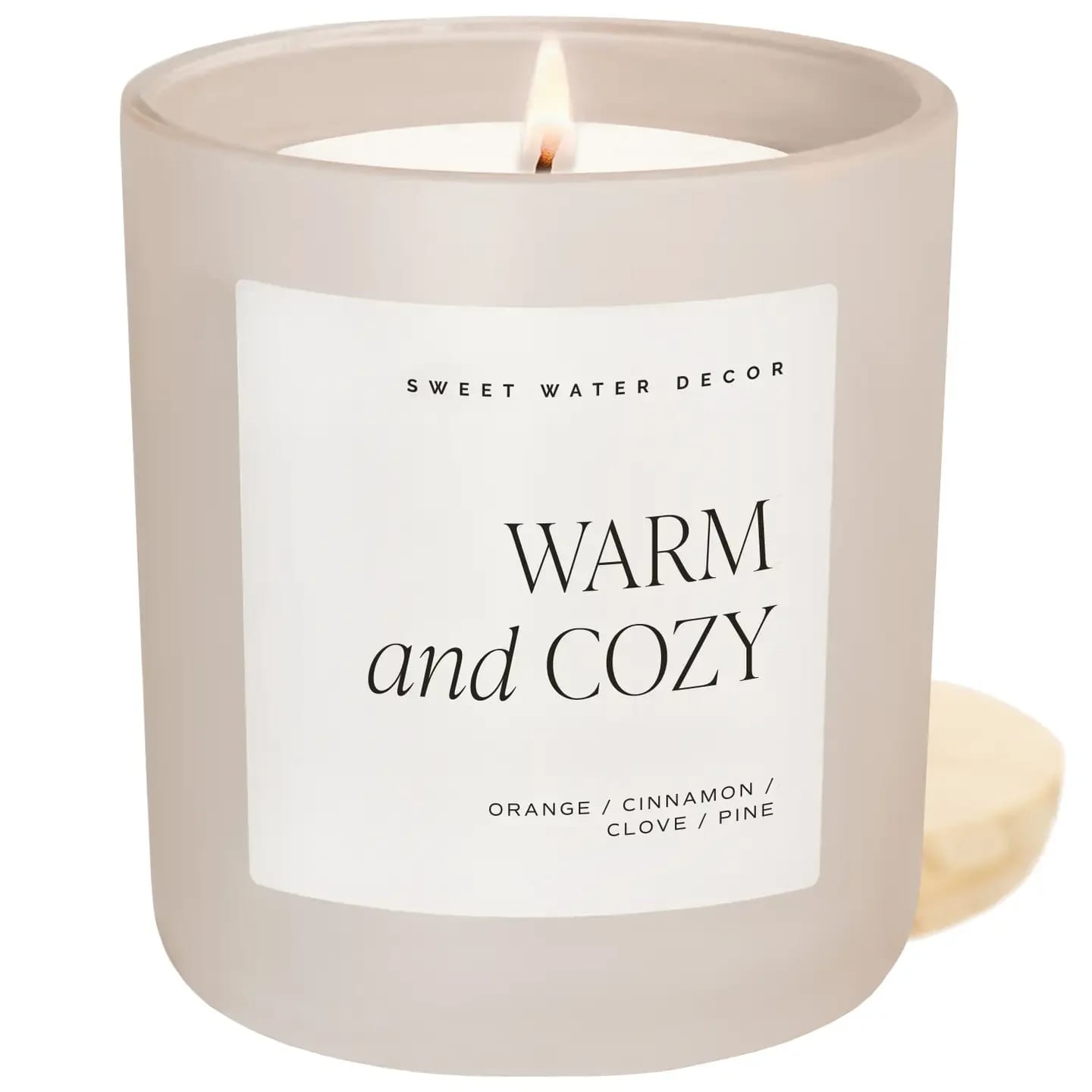 Warm and Cozy 15 oz Soy Candle, Matte Jar Warm and Cozy 15 oz Soy Candle, Matte Jar - Our best-selling Warm and Cozy fragrance works throughout Fall, Autumn, and Christmas with transitional notes of pine, sweet orange, cinnamon, cypress, and fir. Perfect for crisp evenings, Thanksgiving gatherings, and festive holiday moments, this scent fills any space with warmth and nostalgia. Voted "Best Fall Candle Overall" by Forbes Vetted (2022)! SCENT NOTES: • Top: Orange Peel, Cinnamon, Ginger • Middle: Clove, Cypress • Base: Vetiver, Pine, Fir Balsam CANDLE INFO: • Size: 15oz | 334g Net Weight | 3.25 x 3.63 x 4" • Burn Time: 70+ Hours • Includes wood lid • Wick: 100% Cotton (Lead & Zinc Free) • Wax: Proprietary Soy Based Wax Blend | Vegan, Non-GMO, Kosher • Premium Fragrance Oil • Gluten Free, Phthalate Free, Non-Toxic • Made in Pittsburgh, PA • Style No. CL102