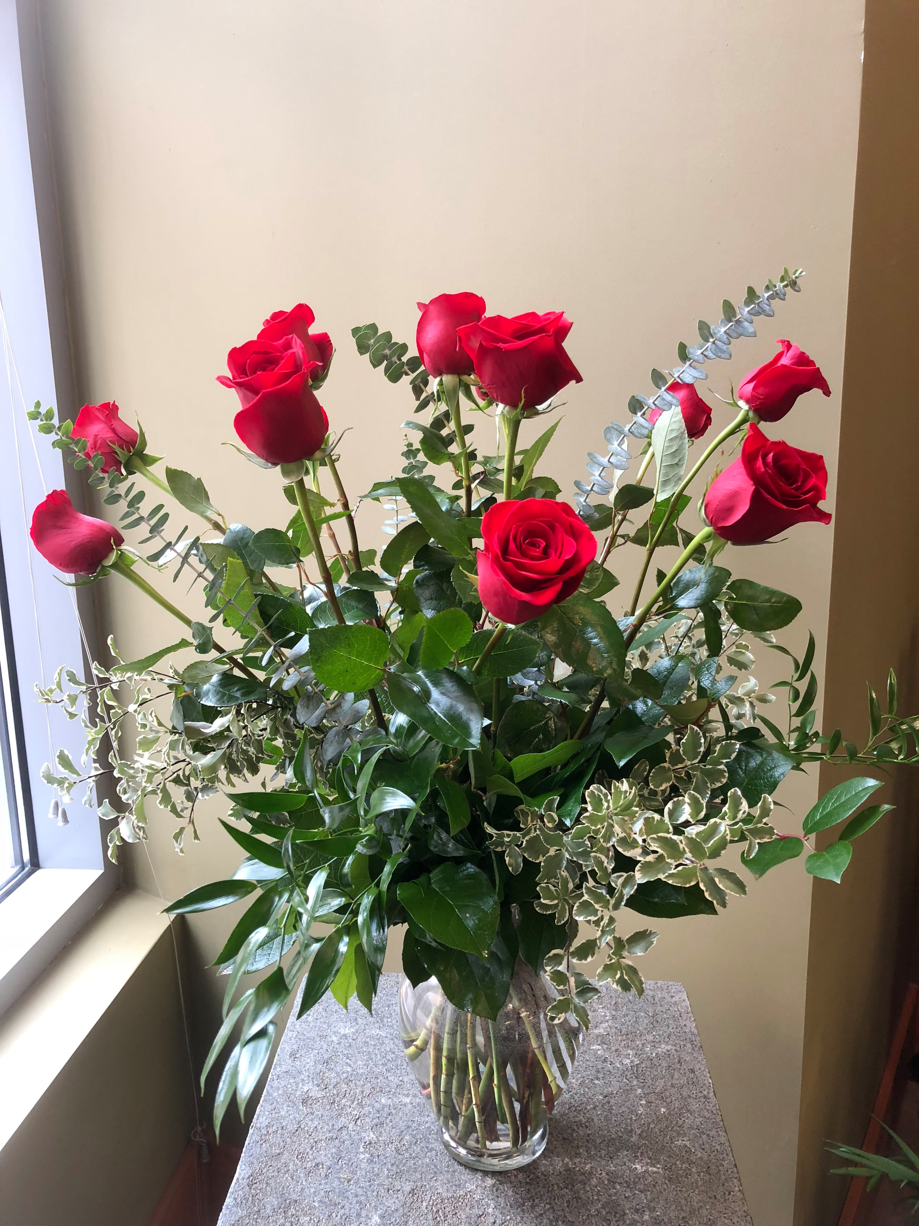 Dozen Long Stem Red Roses - One Dozen Long Stem Roses in Clear glass vase with assorted greenery and filler. Approximately 26&quot; to 28&quot; tall 