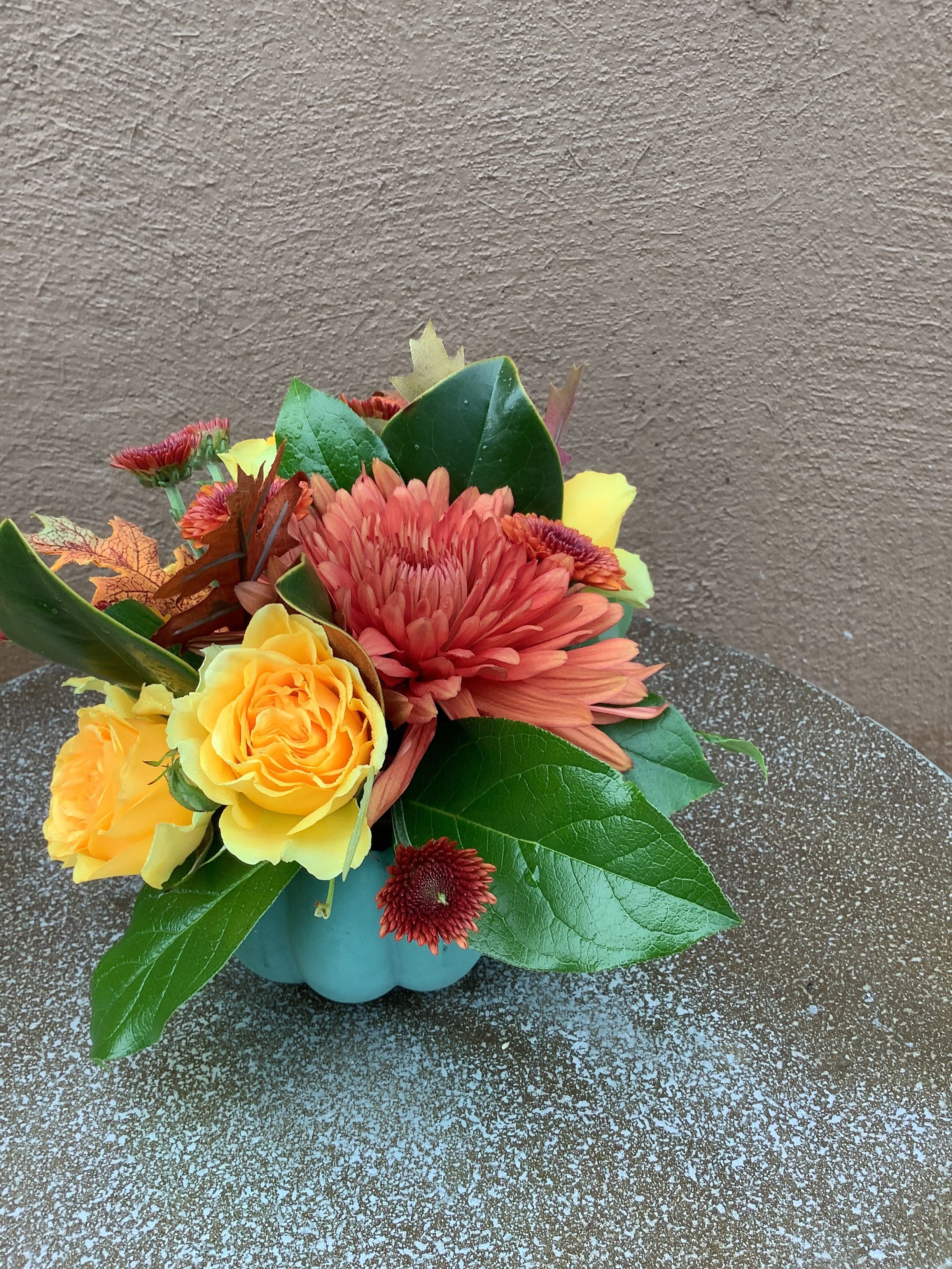 Cute Little Pumpkin Diddy  - An assortment of fall blossoms in a sweet little ceramic pumpkin, colors and flowers may vary.