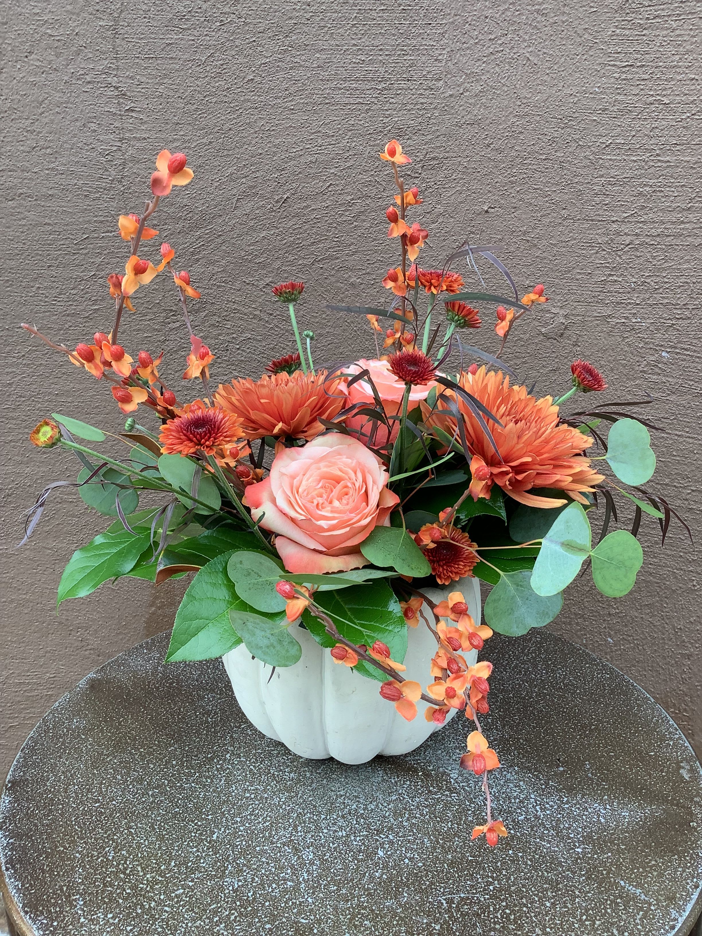 Pumpkin Centerpiece  - A beautiful ceramic pumpkin filled with a beautiful selection of fall flowers.