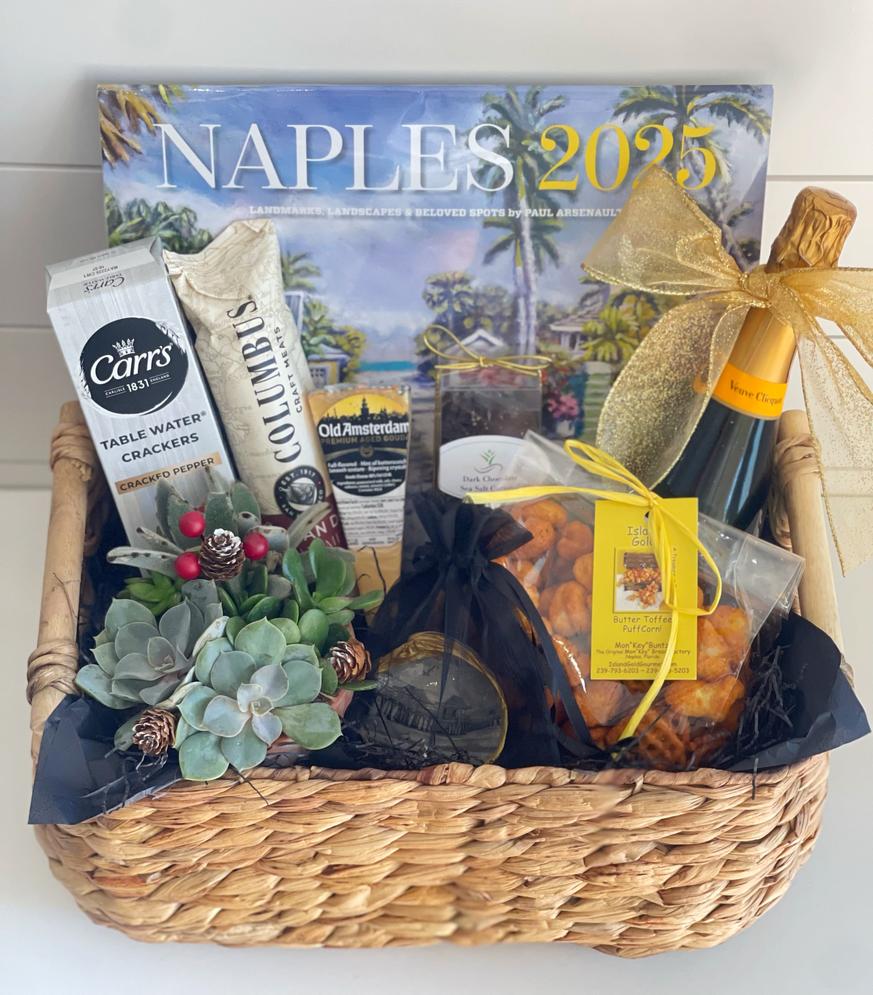 2025 with Champagne  - Send a gift basket for Celebrating and Welcoming the New Year! This basket includes: -2025 Calendar featuring original paintings by Naples artist, Paul Arsenault -Christmas shell ornament made locally by Naples artist in an organza bag -truly addicting toffee Puff Corn form Tin City’s MonKey Buntz -Veuve  Clicquot Champagne  -dark chocolate sea salt chocolates -salami -Gouda cheese -Carrs crackers -potted succulent arrangement -quality reusable basket