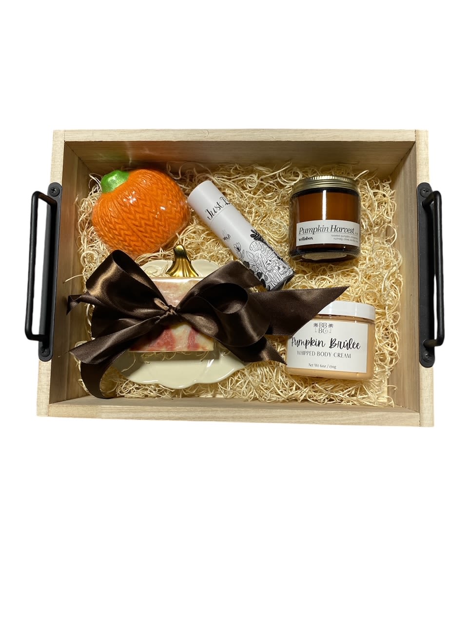 Fall Box Gift  - About this Certainly! Here's a descriptive paragraph for your fall-themed gift basket:  Embrace the cozy essence of autumn with this exquisite fall gift basket. Nestled within a charming woven wicker basket are carefully curated treasures that evoke the spirit of the season. A warm glow emanates from fragrant candles, ready to illuminate chilly evenings. Delicate matches stand at the ready, promising to ignite moments of comfort and joy. Luxuriate in the nourishing embrace of natural soap, crafted with care to pamper the skin. A whimsical pumpkin dish cradles the soap, adding a touch of whimsy to the ensemble. Indulge in a soothing bath experience with a tantalizing bath bomb, designed to whisk away the cares of the day. Complete the ritual with luscious pumpkin buttercream body cream, a decadent treat for the senses. Each item is thoughtfully arranged, creating a harmonious symphony of fall delights that promise to enchant and delight. This gift basket is a celebration of the season's beauty, a token of warmth and generosity to be cherished and savored.