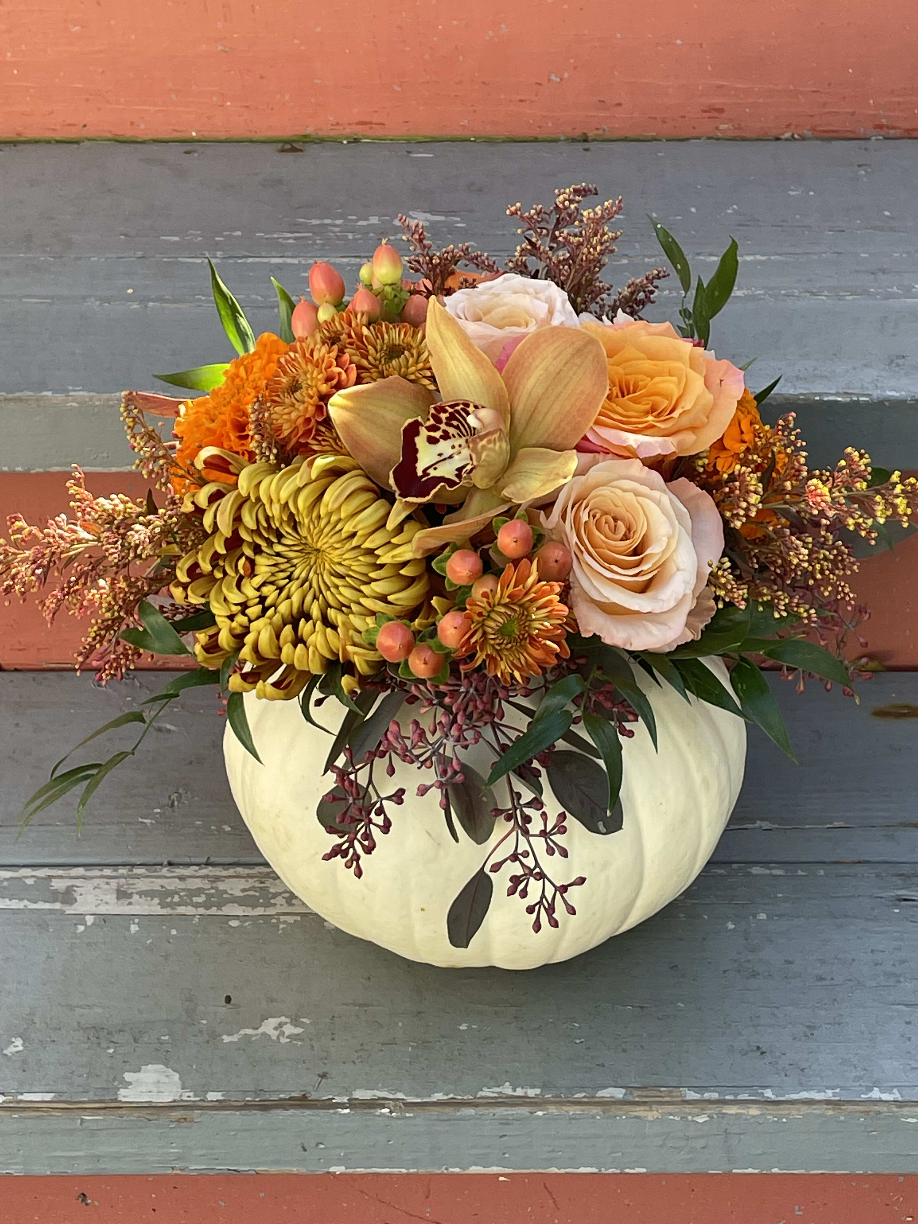 Harvest Pumpkin Harvest Pumpkin - Celebrate the season with this lovely fall arrangement. A small white pumpkin serves as the vase for a beautiful collection of florals in fall textures and colors. Flowers may vary but will always have a harvest/fall vibe. The finished arrangements is a great size for your 4-6 person dining table or a large island or side table. Also great for the office!