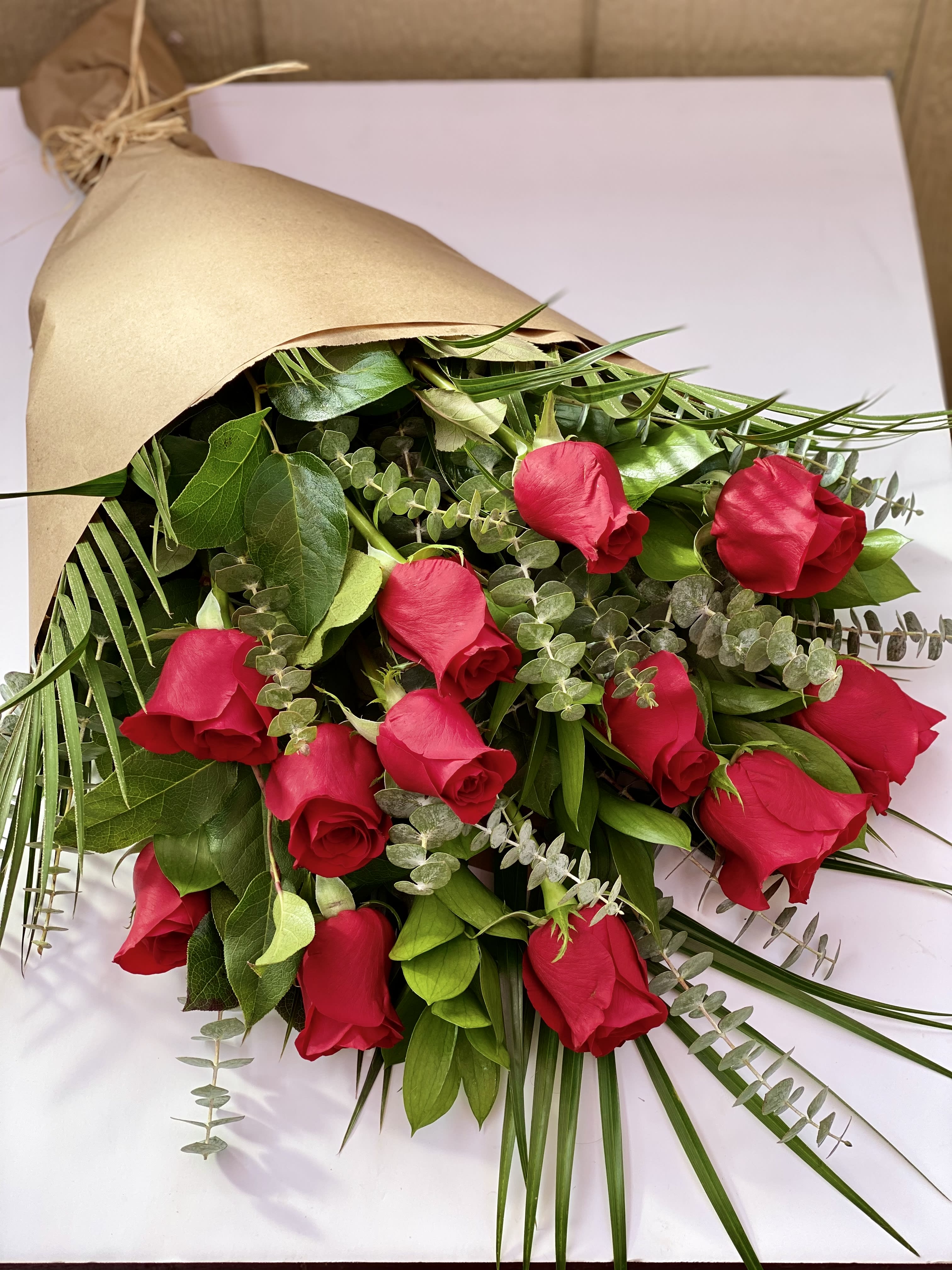 Dozen Roses Wrapped Dozen Roses Wrapped - One dozen Long Stemmed Ecuadorian Roses Wrapped with Premium Greens. Also available in pink, lavender, white, and yellow. Please specify color if other than red