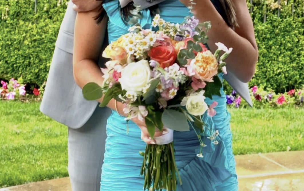 Homecoming  Handheld - A fun handheld bouquet in lieu of the traditional  wrist corsage. These are colorful with seasonal Roses , Stock and assorted blooms. You may specify the color preference in notes and we can most definitely accommodate!