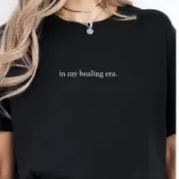 In My Healing Era T-Shirt S-XXL In My Healing Era T-Shirt S-XXL - Simple black T-shirt with "in my healing era." text, available in sizes S-XXL.