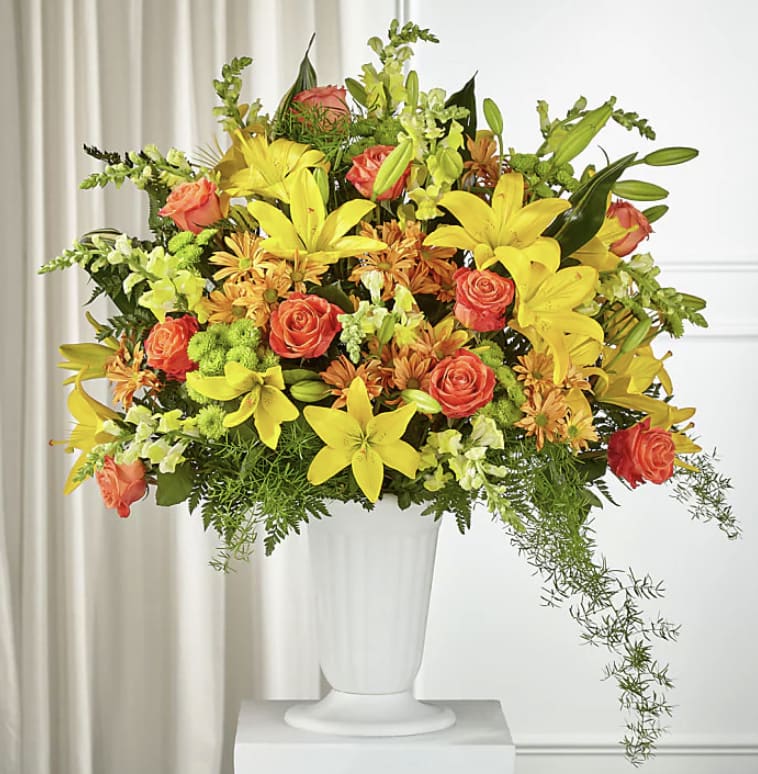 Friends of Grace Friends of Grace - Stunning yellow lilies, bold orange roses and beautiful yellow snapdragons make this arrangment bold, grand and gorgeous for your loved one.