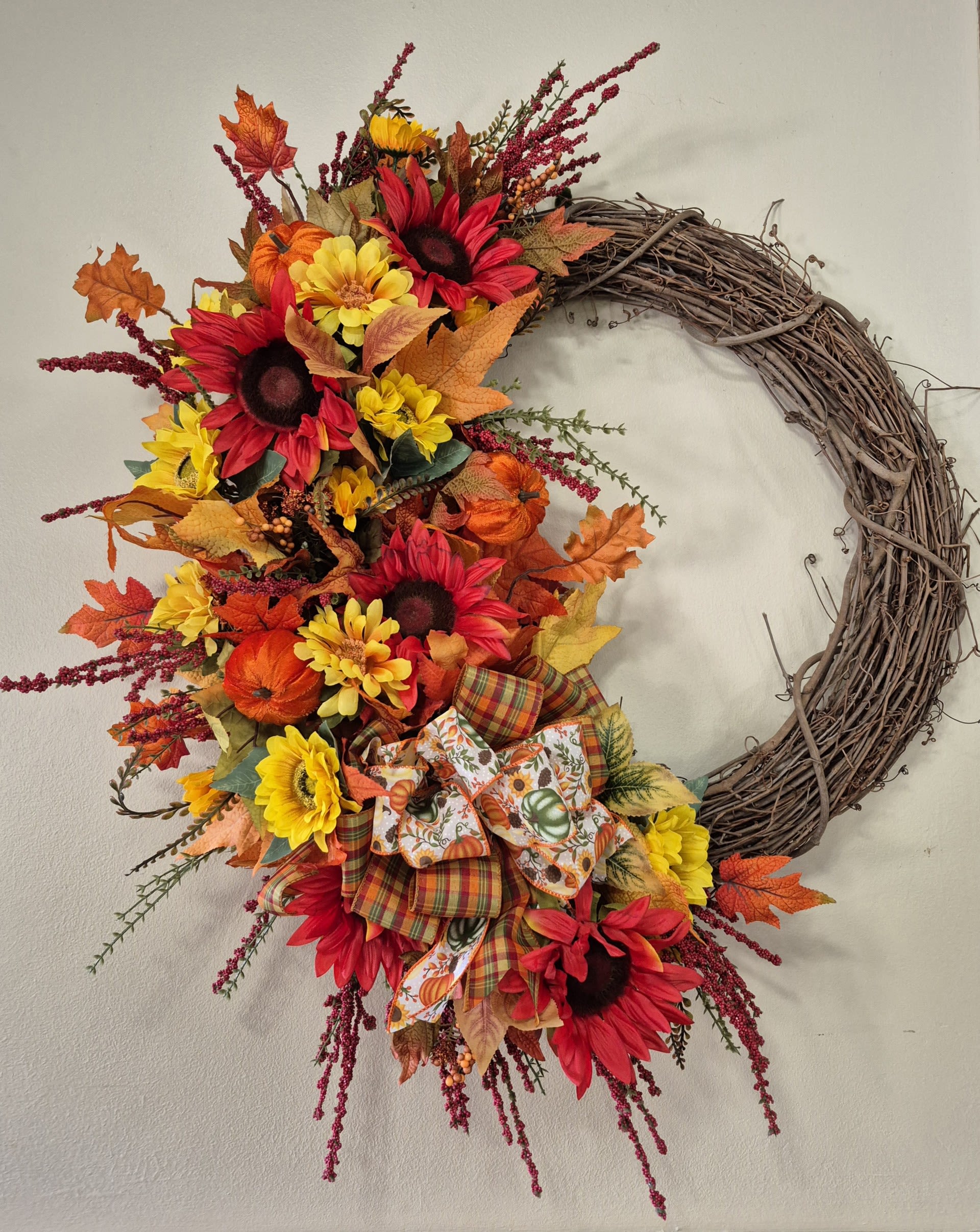 Autumn Grapevine Silk Wreath Autumn Grapevine Silk Wreath - Get your door ready for Fall with this beautiful grapevine Welcome To Our Home wreath. This handcrafted wreath is the perfect addition to your autumn decorations or a gift to someone. Featuring a beautiful mix of orange and yellow hues that bring vibrant colors of fall right to your doorstep. Height 34" Width 26"