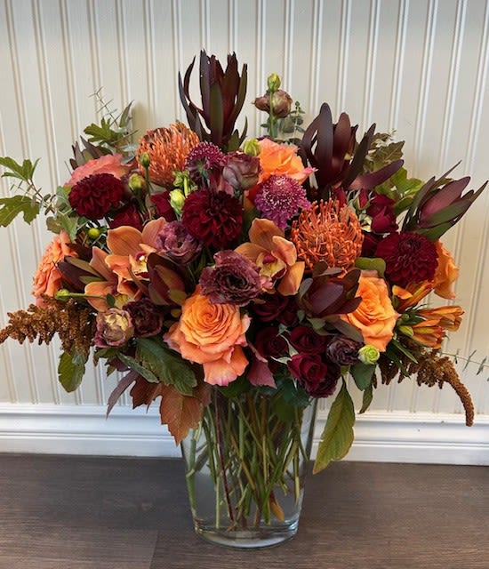 Amazing Autumn Amazing Autumn - A Tall and showy autumn floral arrangement with deep burgundy and orange premium floral blooms.
