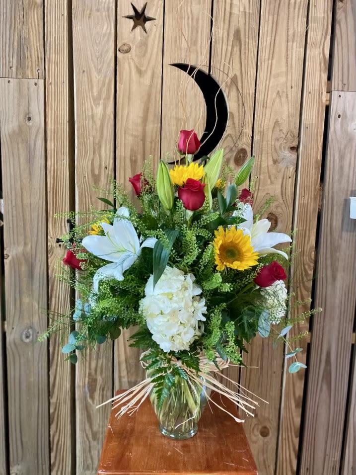 Sunshine Harvest Bouquet Sunshine Harvest Bouquet - Sunflowers, white hydrangea, red roses, and white lilies with curly willow and lepidium arranged in a vase with a twine shoestring bow.