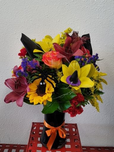 Halloween Beauty Roses. Halloween Beauty Roses. - Fall color flowers, Roses, Lilies, carnations, daisies, purple and yellow filler black vase decorated with spider.