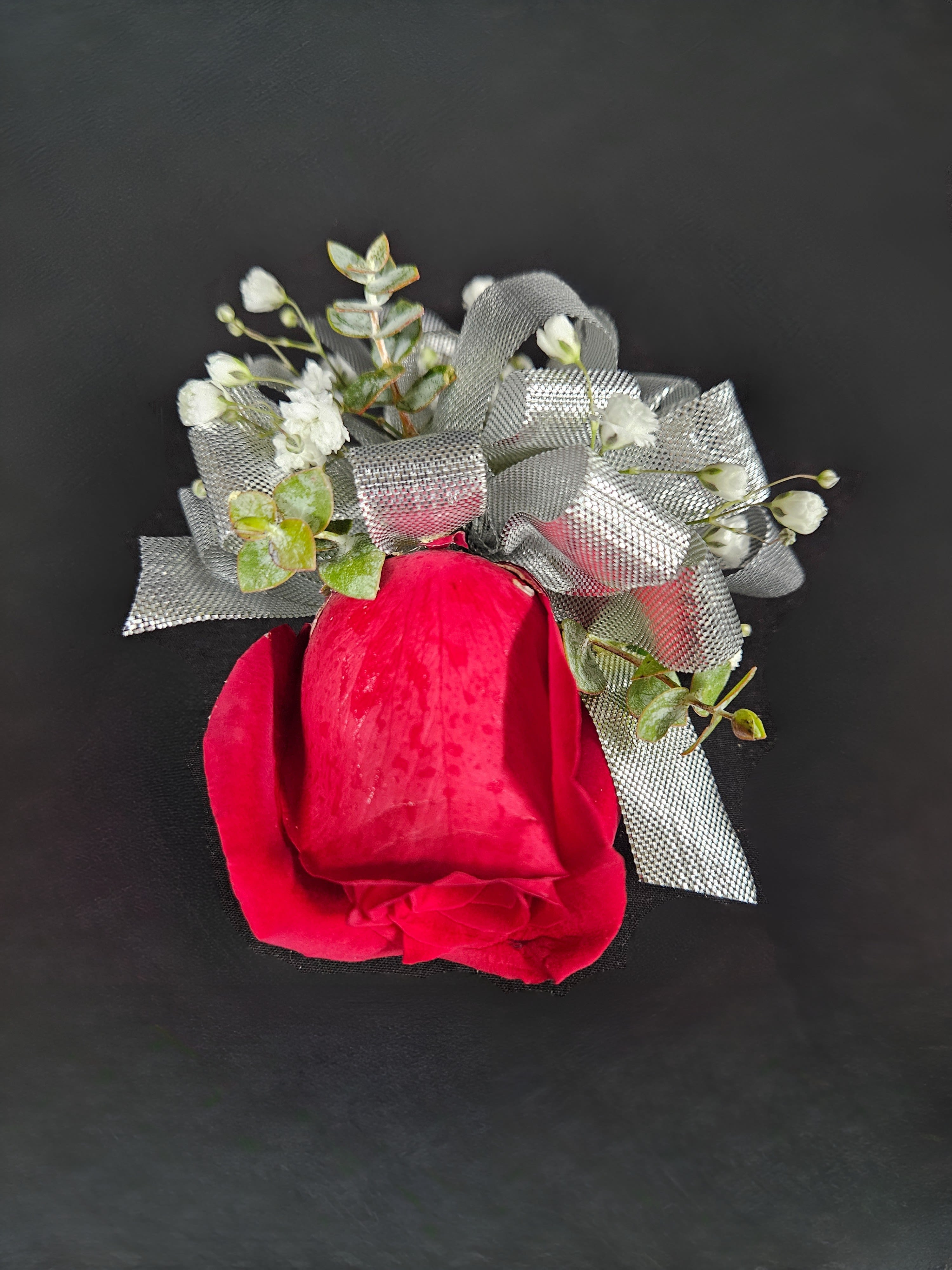 Rose Corsage (Customizable) Rose Corsage (Customizable) - A beautiful rose corsage with ribbon and babies breath. Available in White, Red, Pink, Orange, Lavender, or Yellow. Ribbon color can also be customized to match. Available with a Single Rose (Standard) or Double Rose (Deluxe). Available for wrist or pin on.
