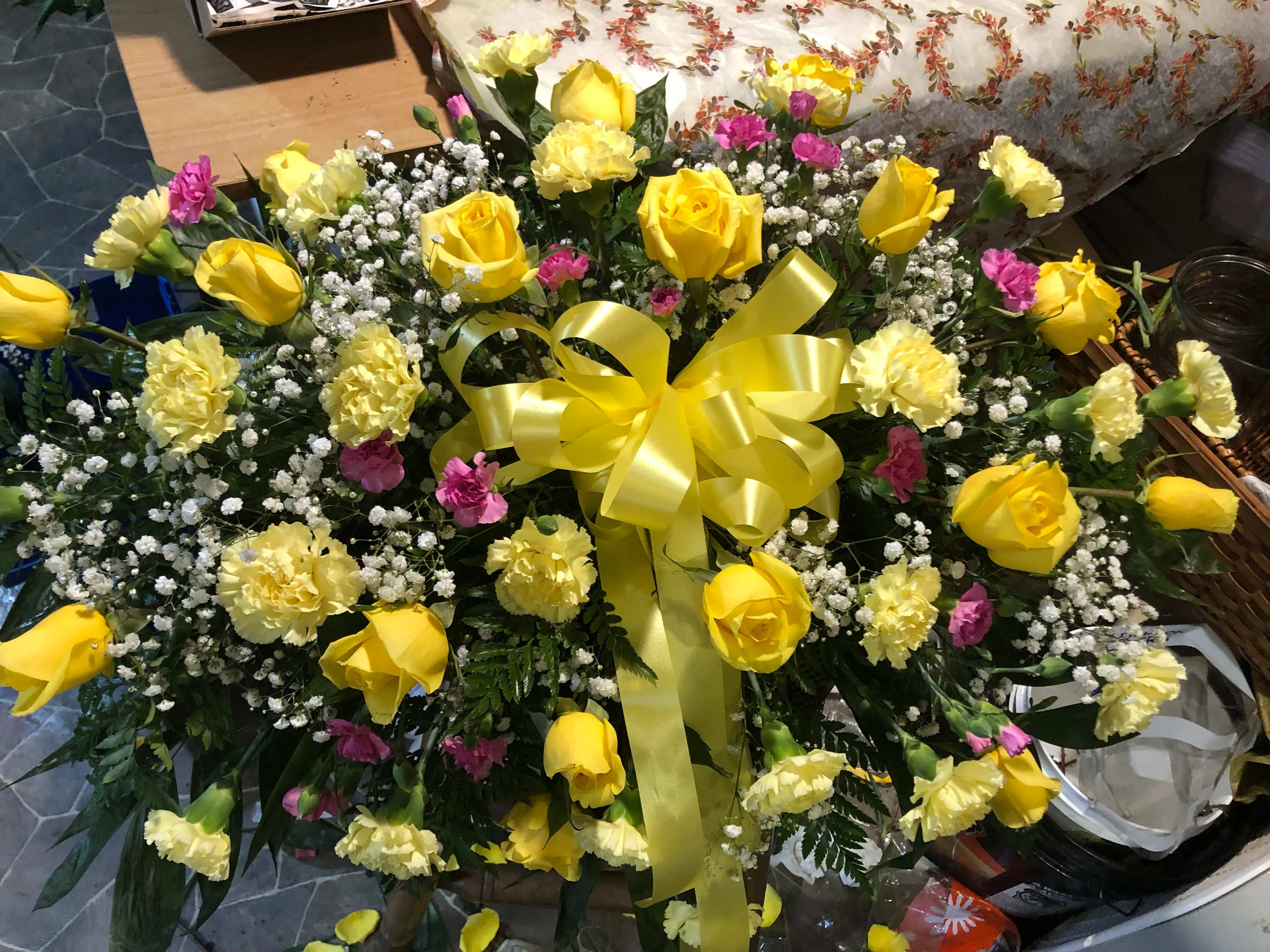 Golden Memories Casket Spray Golden Memories Casket Spray - Joyous times and golden memories are recalled with this lovely casket spray that consoles the bereaved with a sunny array of beautiful blooms.