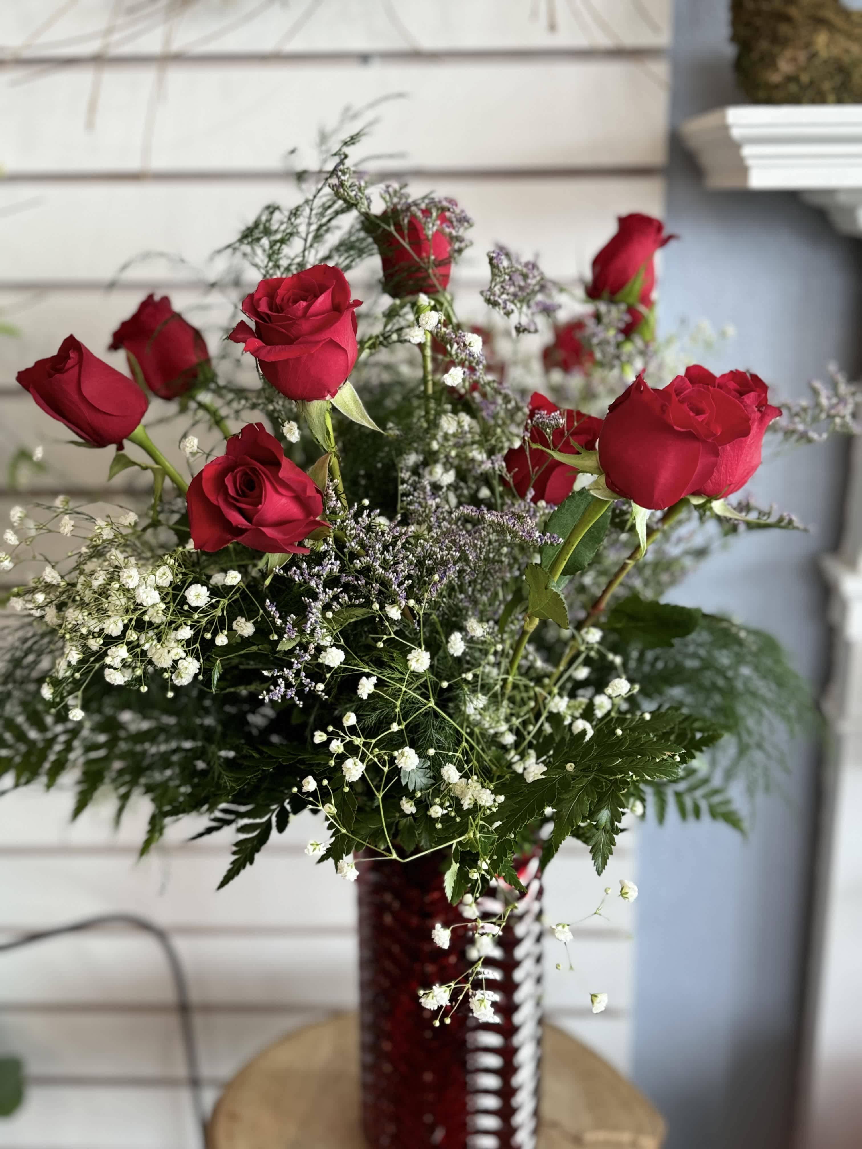 Dozen Red Rose Vase Dozen Red Rose Vase - These dozen red roses with baby's breath in a vase are classic! A variety of colors are also available depending on what is fresh in the shop.