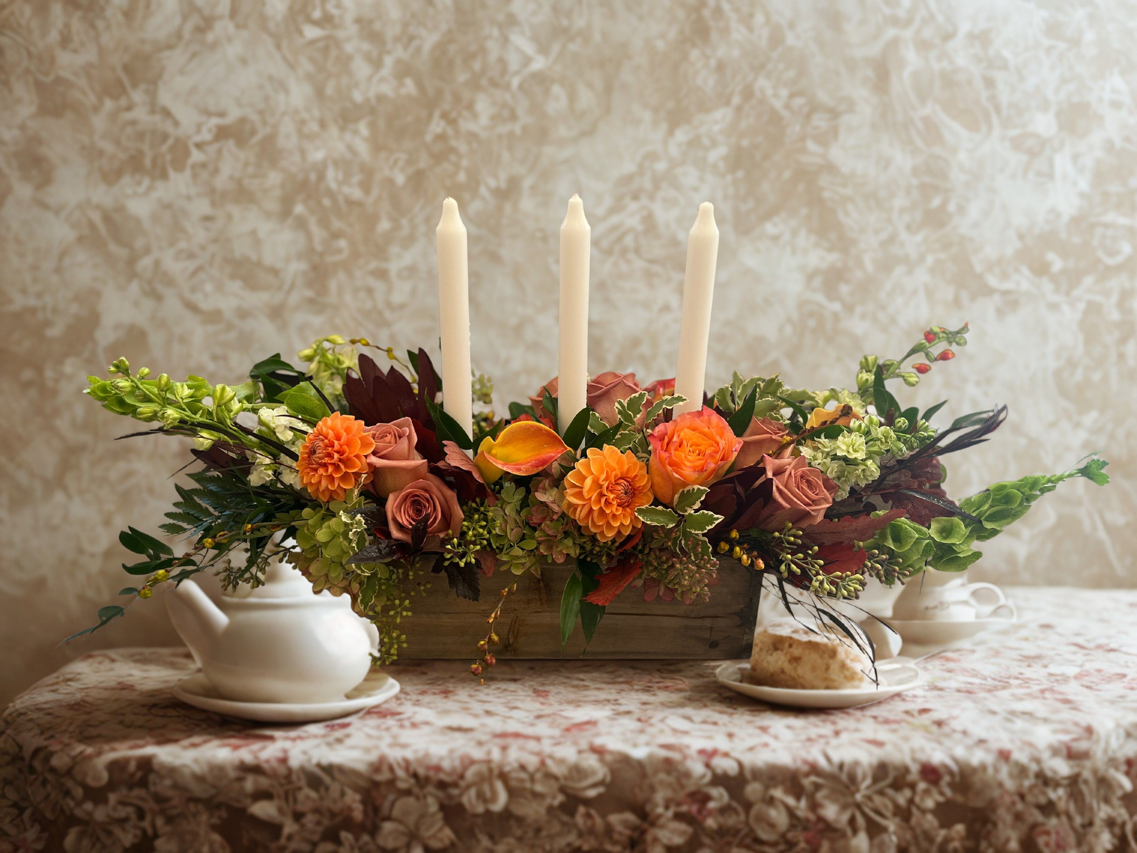 Harvest Gathering Centerpiece  - Celebrate the season of family with this traditional table centerpiece. Including three tape candles, this abundant design features some if our favorite blossoms in elegant autumnal colors.  Approx 20&quot; long and 15&quot; high with candles.   *available in other color palettes such as whites and greens or pastels. Please include in notes section. 