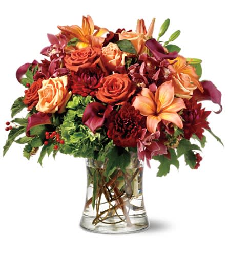 Beautiful Impression Beautiful Impression - Want to make a beautiful impression? Start here. With an artful mix of the season's colors and textures - from golden peach to rich burgundy - this gift's as unforgettable as its sender. • A profusion of fall-toned flowers including Asiatic lilies roses cymbidium orchids miniature callas hydrangea dahlias and accents of viburnum berries and curly willow arrive tucked inside a clear glass gathering vase. Approximately 18" (W) x 17" (H) Orientation: All-Around As Shown : TF-WEB64