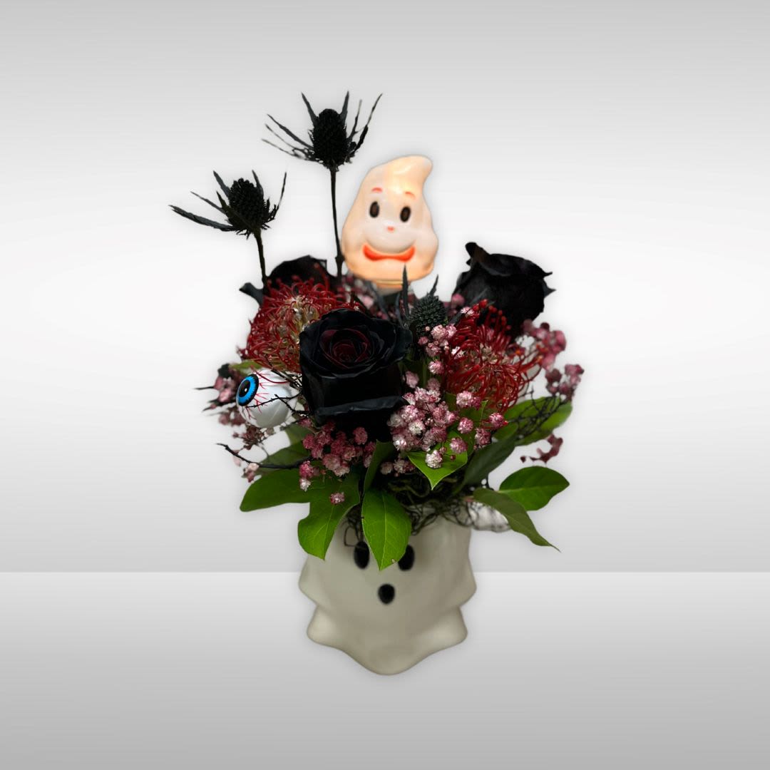 BOO in Ghost Mug BOO in Ghost Mug - Recipe: Black Roses, Black Eryngium, Protea, Babies Breath, Moss and more in a white ghost mug. Availability: All year round Design View: Symmetric Front Facing View Photo shown: Standard