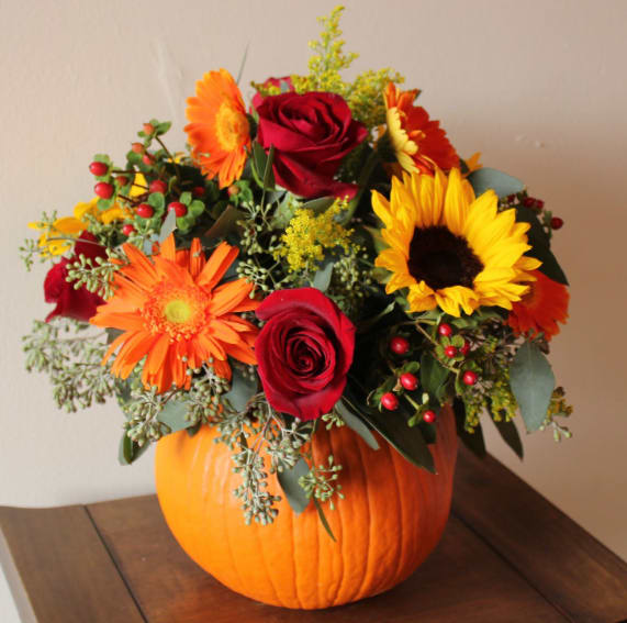 Pumpkin Harvest Pumpkin Harvest - Fresh pumpkin with sunflowers, gerbera daisies, and roses. Makes an adorable centerpiece for the holidays.