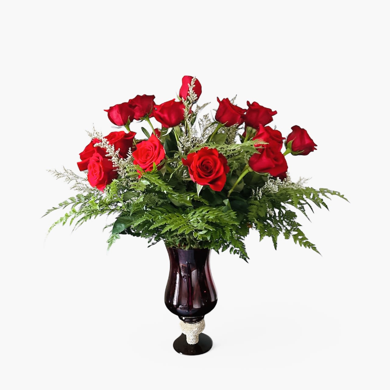 Rose Elegance Red Rose Elegance Red - Rose Elegance. A sophisticated arrangement that embodies the classic beauty of red roses. Surrounded by delicate limonium and lush greenery, each rose stands out, radiating elegance and charm. 30”H x 25” W
