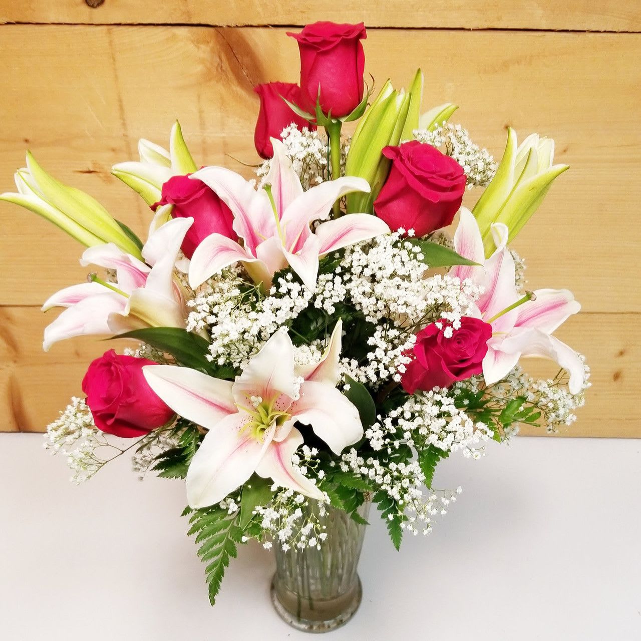 Always on My Mind Always on My Mind - Always on My Mind is a heartfelt expression of love and remembrance, delicately crafted to convey deep emotions. This elegant bouquet features radiant red roses paired with soft pink and white lilies, symbolizing passion and purity. Accented with airy sprays of baby's breath and lush greenery, the arrangement is set in a timeless glass vase, adding a touch of grace and sophistication. Perfect for romantic gestures, anniversaries, or as a beautiful tribute, this arrangement speaks volumes when words fall short.   Approx. 24" H x 16" W   PLEASE NOTE: Some flowers, vases and other products pictured are subject to availability, and may be substituted for a similar item if unavailable according to our substitution policy.