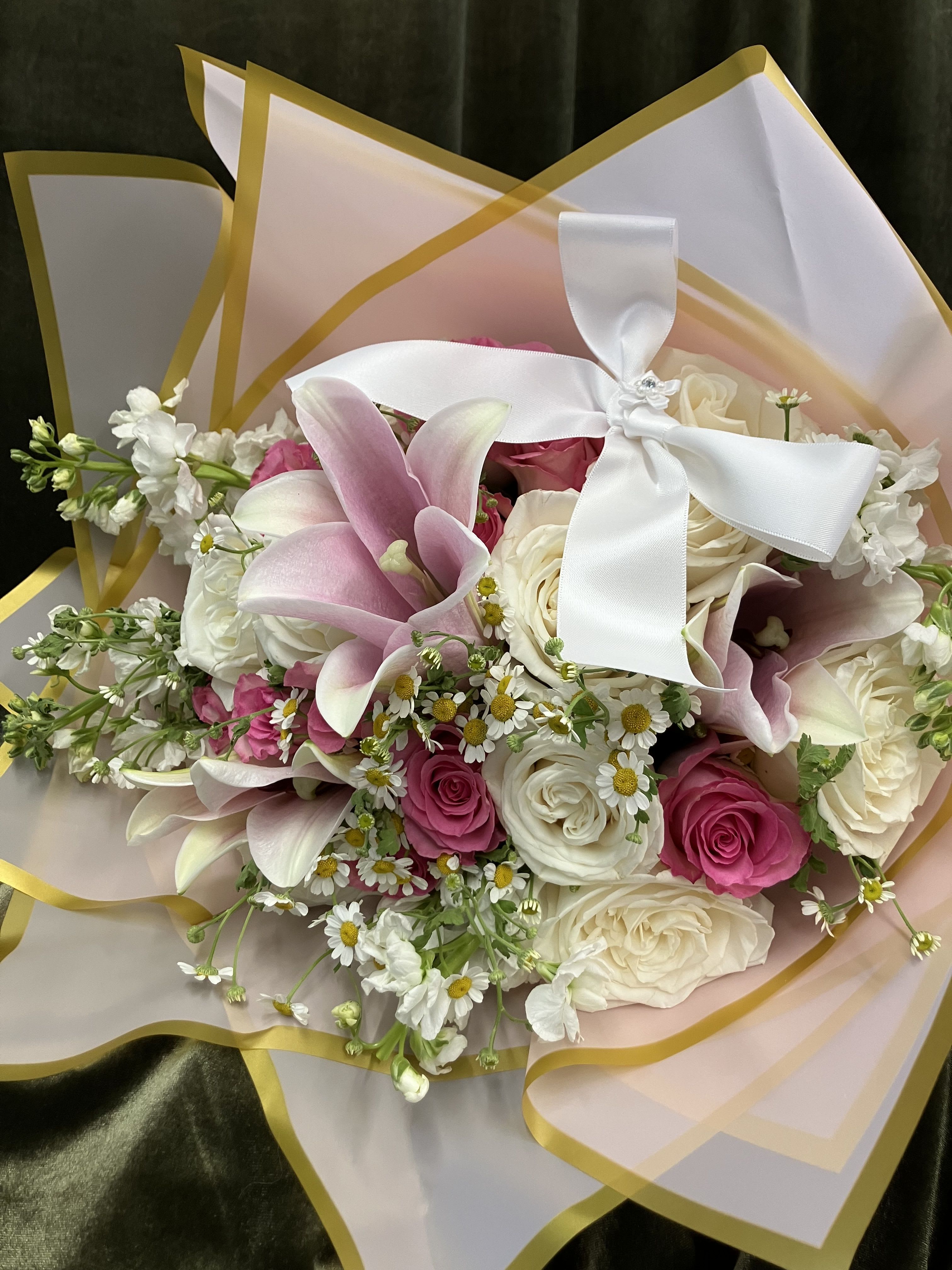 Pink Dream Pink Dream - Wrapped florals in pink and white, fragrant roses, lily and stock with chamomile make a beautiful combination.