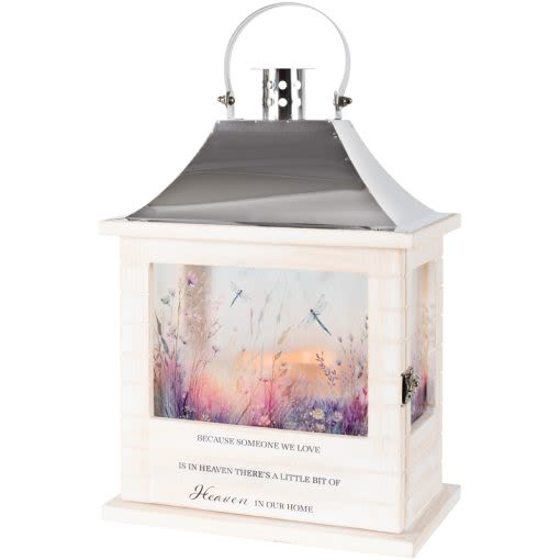 "Heaven In Our Home" Wooden Lighted Lantern "Heaven In Our Home" Wooden Lighted Lantern - Our Wooden Slat lanterns are made with wood with a stainless steel finish top. They come inscribed with sentimental quotes and beautiful artwork on all four sides and a charming flameless LED candle. Suitable for hanging or use as a freestanding item. They are weather friendly! 3 AAA batteries are included. Lantern Reads: "Because someone we love is in Heaven, there is a little bit of Heaven in our home" W: 8.75" H: 12.5" D: 5.25"