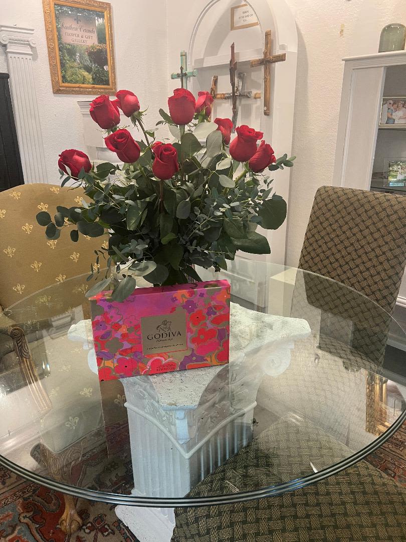 Dozen Red Roses and Box of Godiva Chocolate Dozen Red Roses and Box of Godiva Chocolate - These beautiful red roses and box of Godiva Chocolates are the perfect treat for any occasion! The roses come in a beautiful pink ribbed vase.