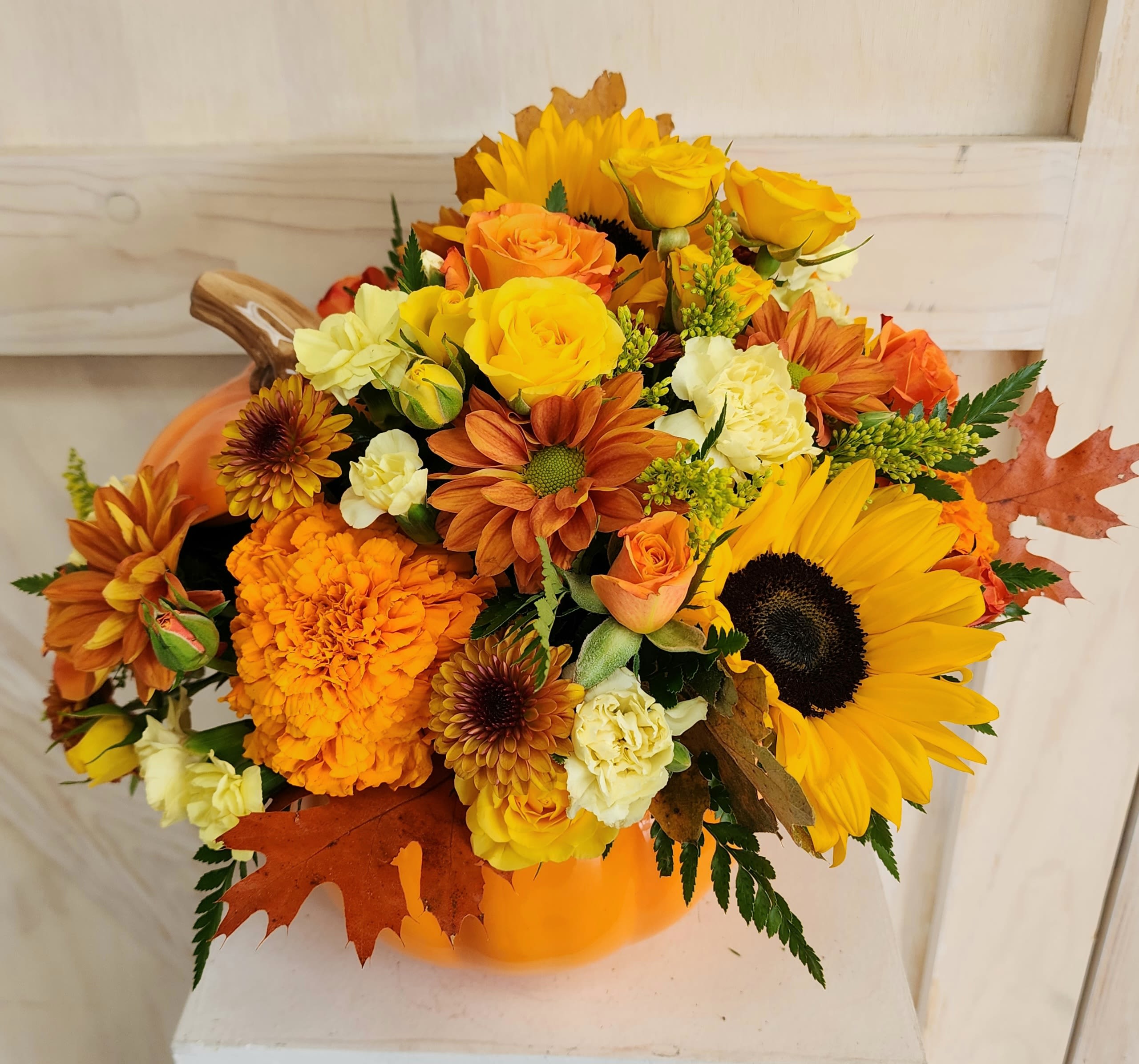 Shinning Pumpkin Shinning Pumpkin - Orange ceramic pumpkin with beautiful sunflowers, roses, marigold and fall fillers.