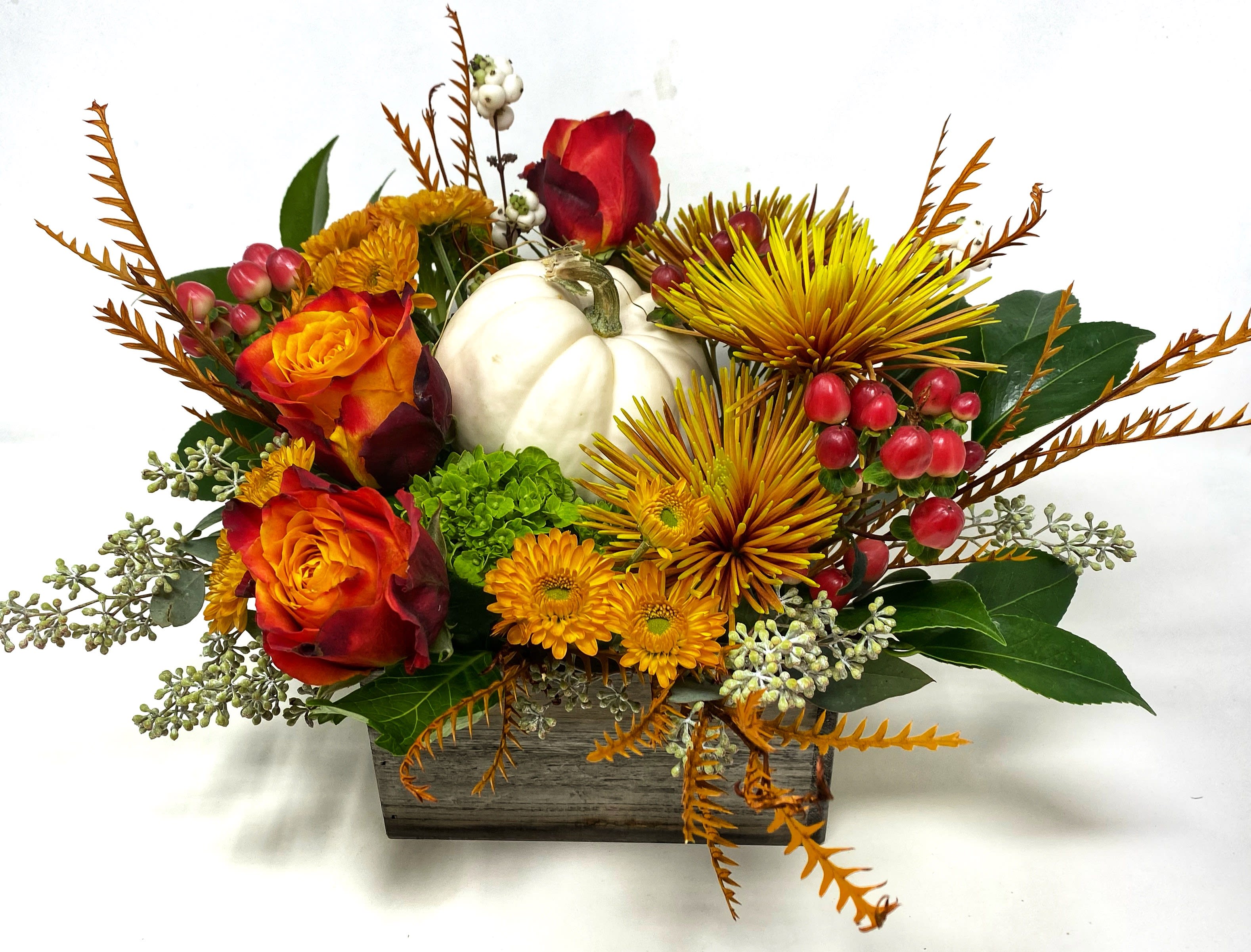 Pumpkin Patch Pumpkin Patch - A low and lush arrangement designed in a square wooden box. Featuring a decorative gourd surrounded by seasonal flowers and colors